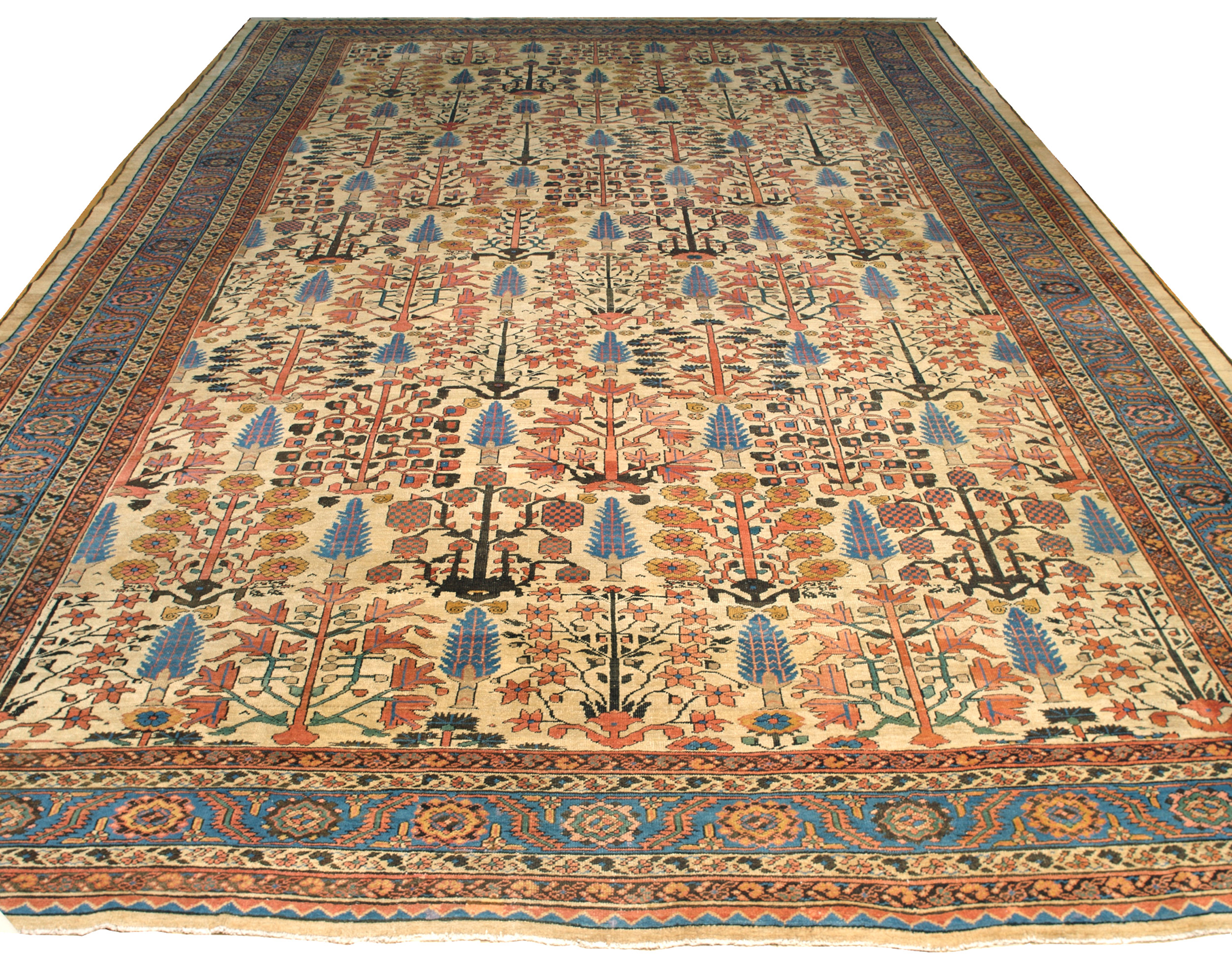 An antique Persian Bakshaish carpet of large size at approximately 13'5" x 18'7". The ivory field is decorated with a Shrub and Flower design and framed by a deep sy blue border. Douglas Stock Gallery, antique Oriental rugs, Natick, Wellesley, Weston, Newton, Brookline, Boston,MA area - antique rugs South Natick,Ma