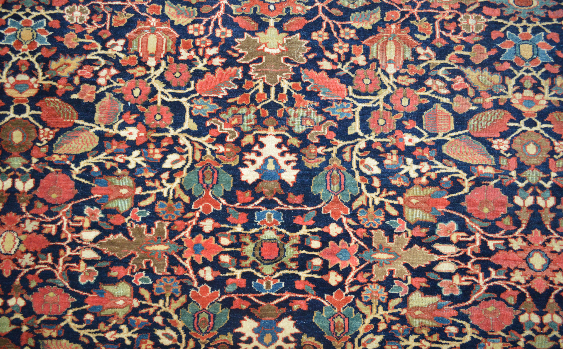 Antique Fereghan Sarouk carpet, central Persia, circa 1910 with an all-over floral design on a navy blue field. This Fereghan Sarouk carpet features a beautiful, wide border that frames the field well. Douglas Stock Gallery, antique Persian carpets, Boston,MA area, New England, antique Oriental rugs