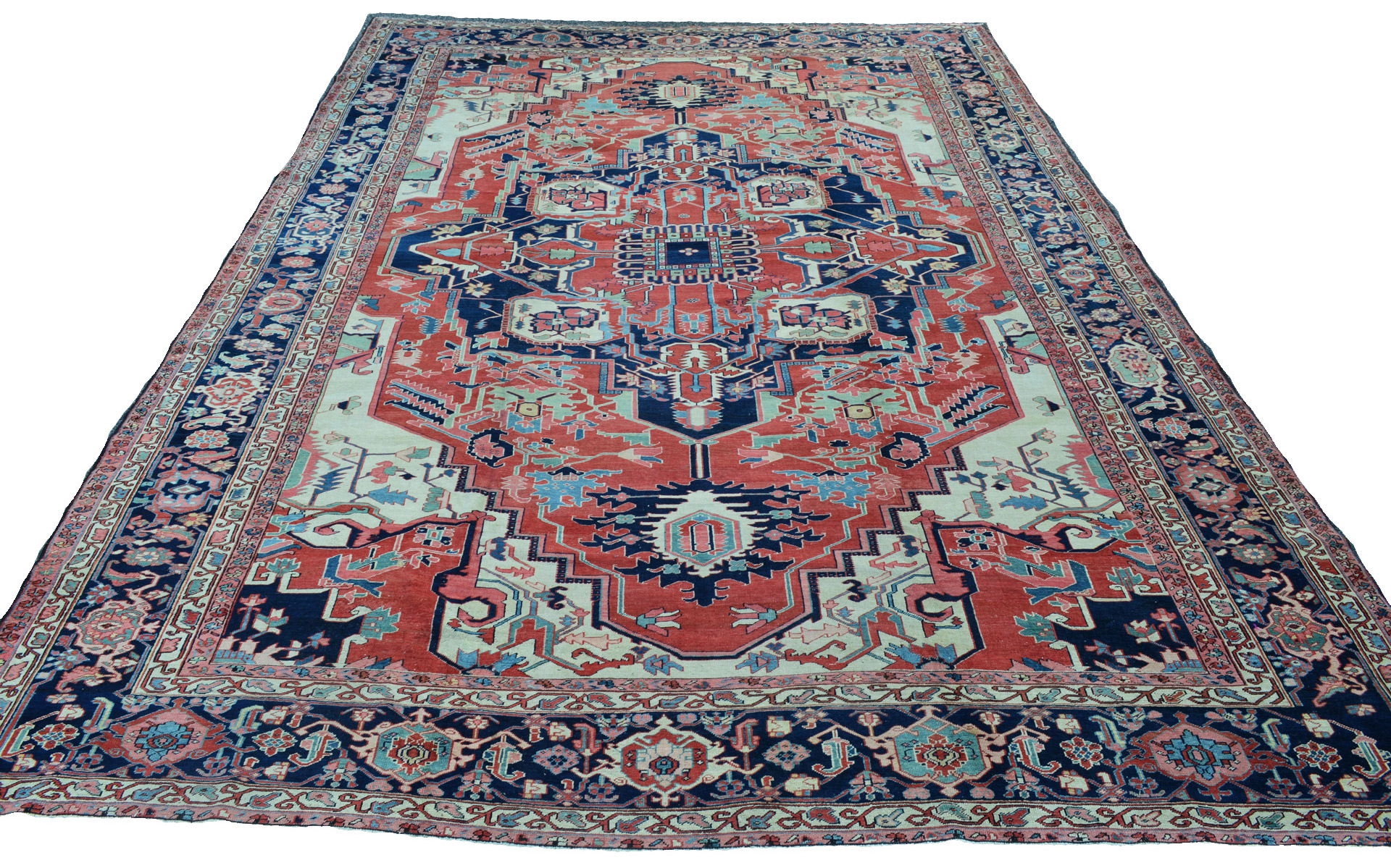 An antique northwest Persian Heriz carpet of the Serapi type with a brick red field and navy medallion.
