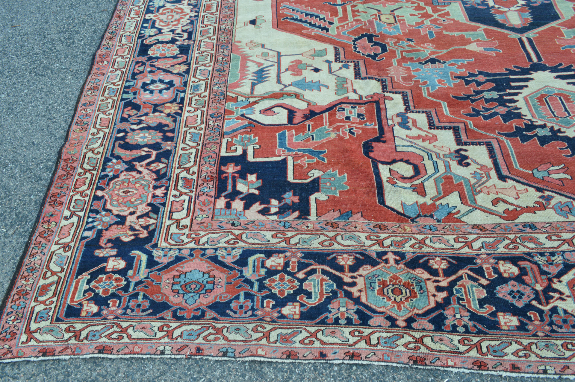 Ivory corner spandrels and navy blue border detail from an antique Persian Heriz Serapi carpet