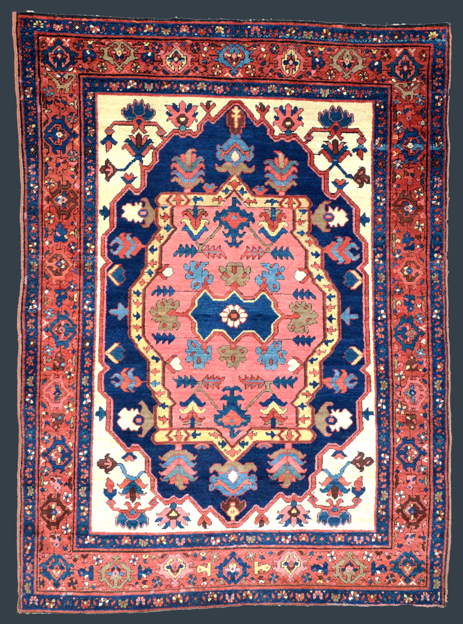 4.5 x 6 Antique Bakshaish rug with a coral medallion on a navy field that is framed by ivory spandrels and a brick red border