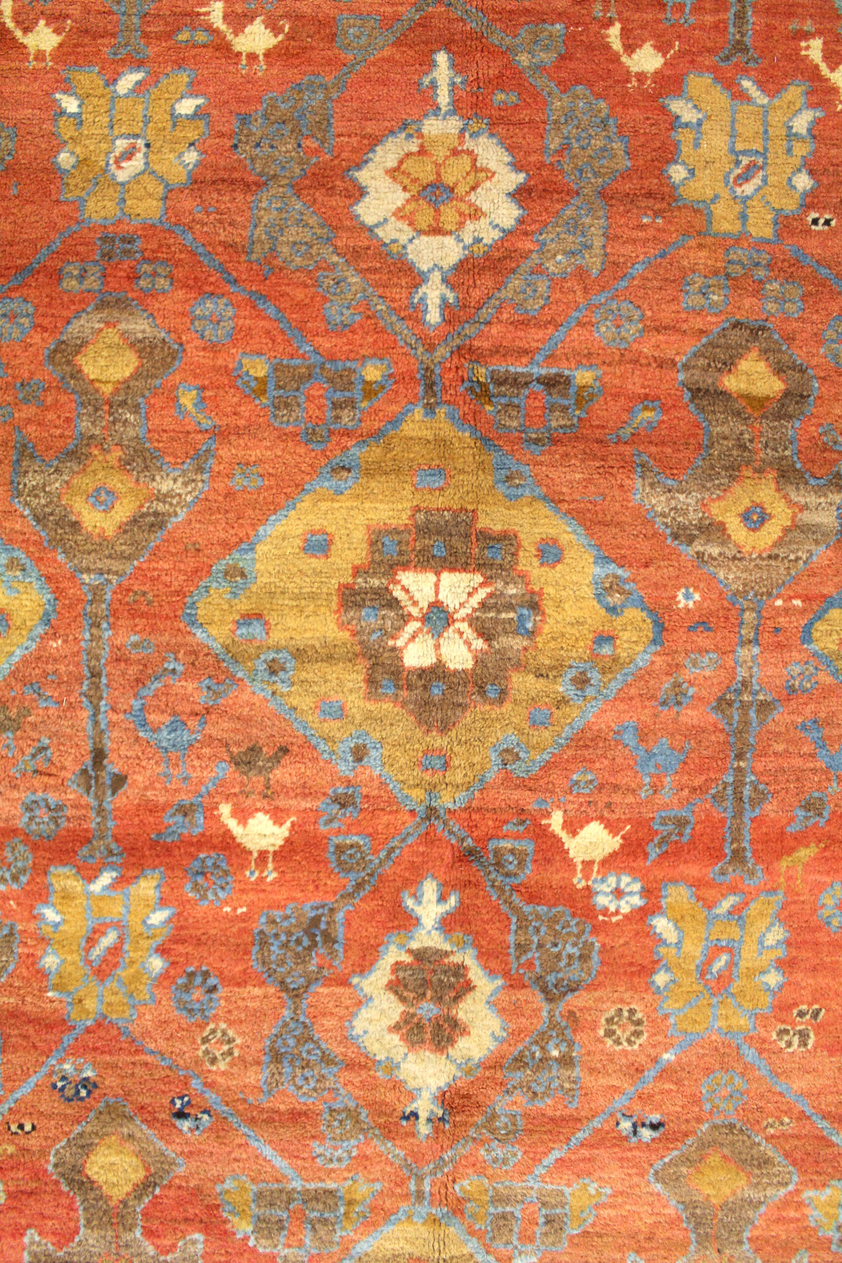 Field detail from an antique Persian Bakshaish carpet with camel color medallions on a salmon color field - Douglas Stock Gallery antique rugs South Natick, Wellesley, Newton, Brookline, Boston,MA area, antique persian carpets New England