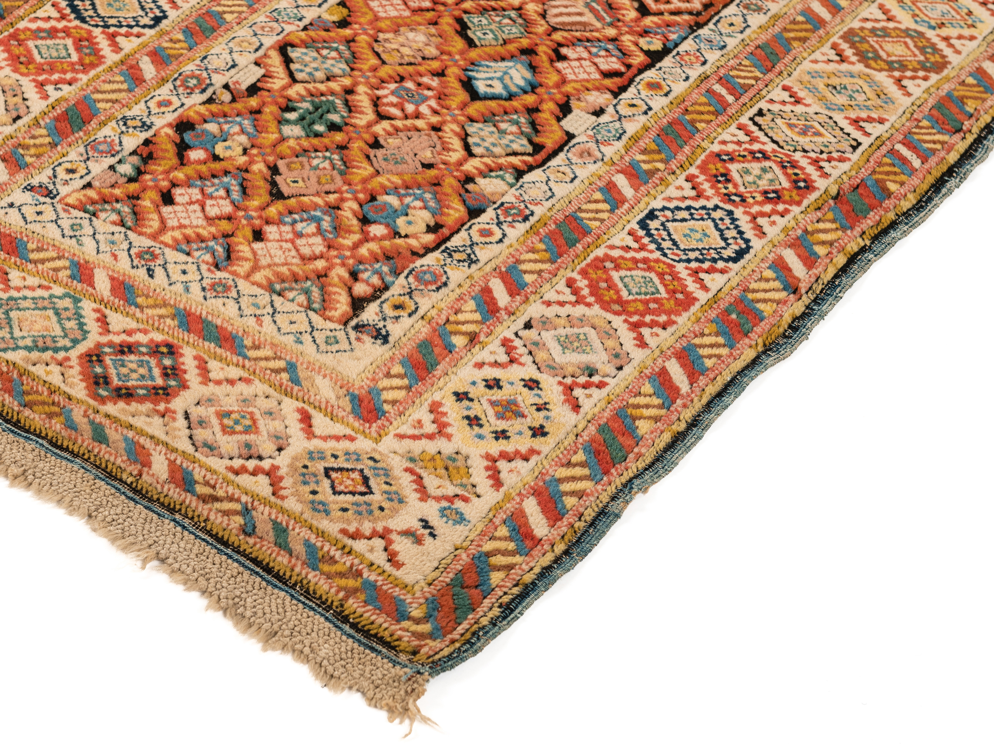 Detail of antique Caucasian Kuba runner with a lattice design on an oxidized brown field that is framed by an ivory border, circa 1880