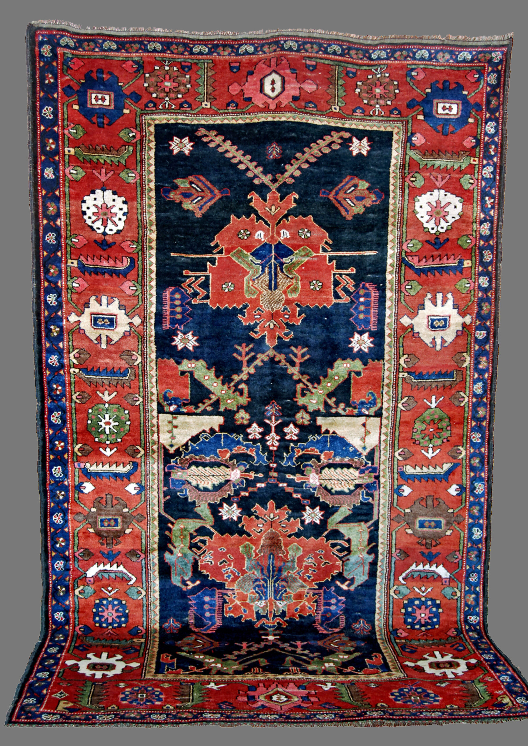 Antique south Persian Bakhtiyari rug with a Caucasian Dragon Carpet related design on a navy blue field with a brick red border