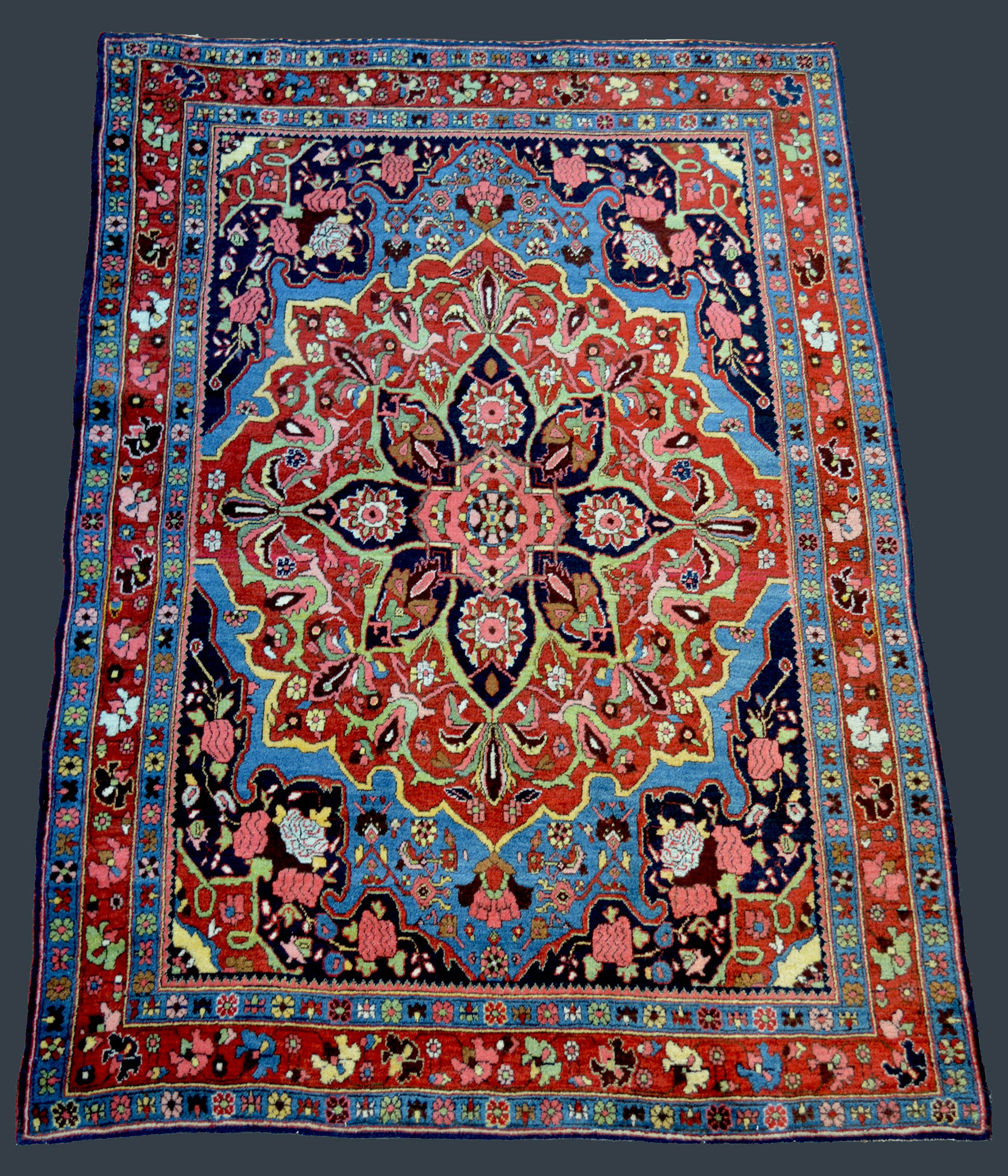 Antique Persian Bidjar rug with a complex medallion on a deep sky blue field