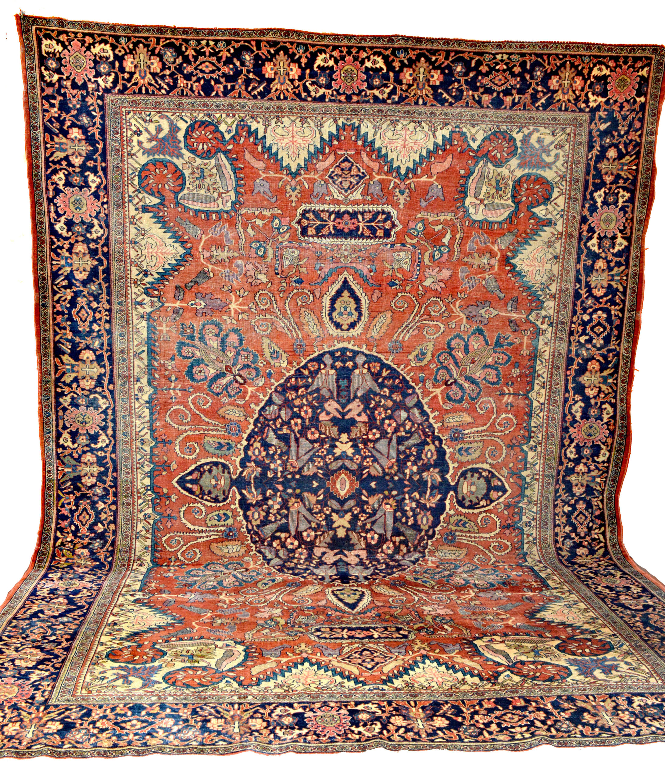 A 19th century central Persian Fereghan Sarouk carpet with a navy blue medallion on a terra cotta color field that is framed by ivory corner spandrels and a navy blue border, circa 1895