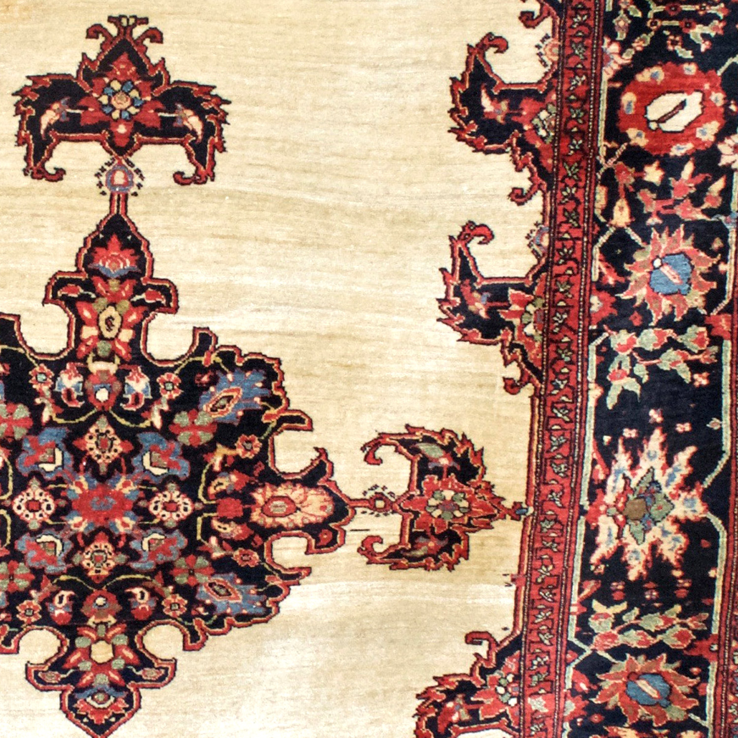 Detail of an antique Persian Fereghan Sarouk rug with an ivory open field and a navy blue medallion with four anchor pendants, central Persia, circa 1885