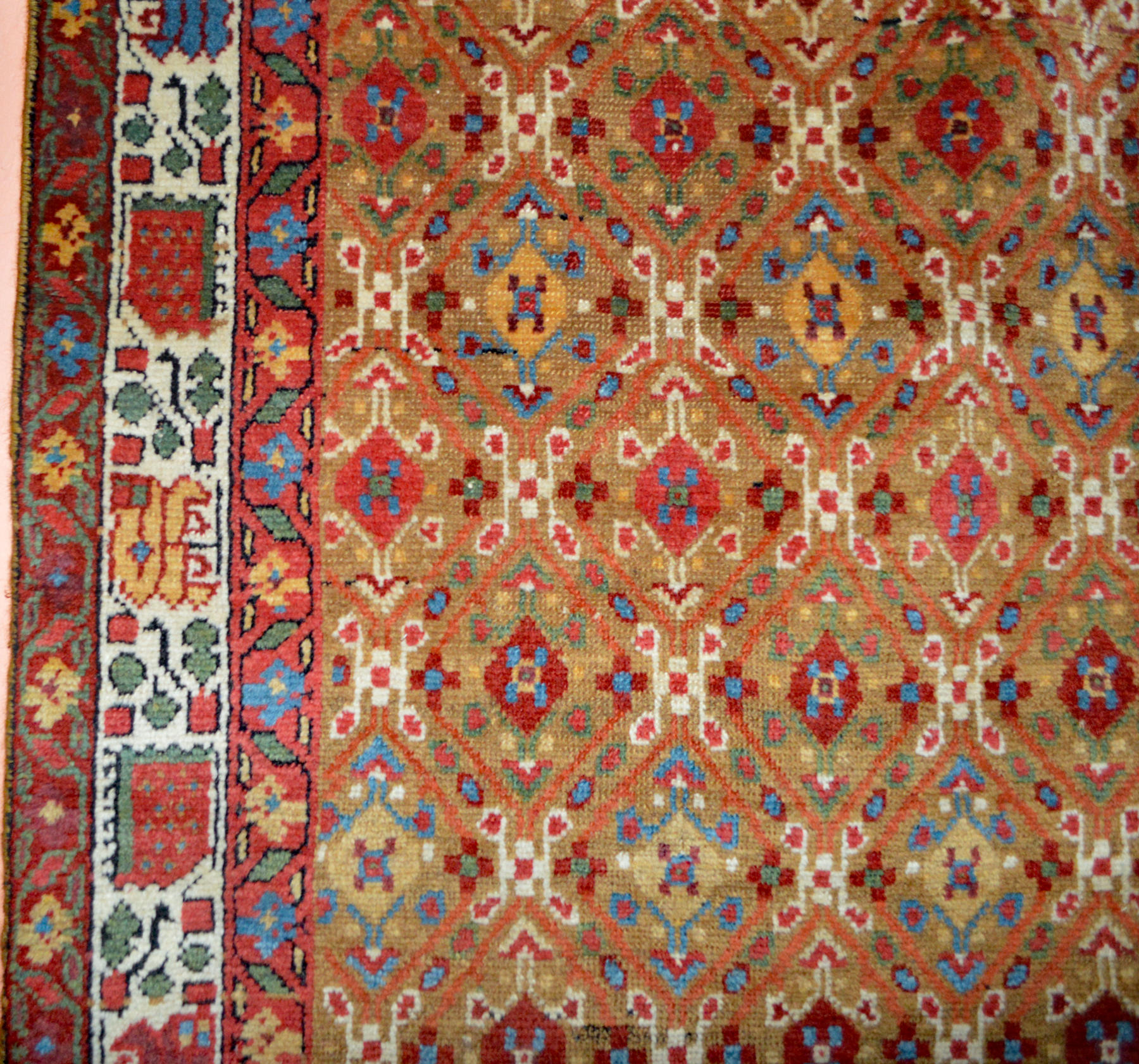 Detail of an antique northwest Persian runner with a camel color field