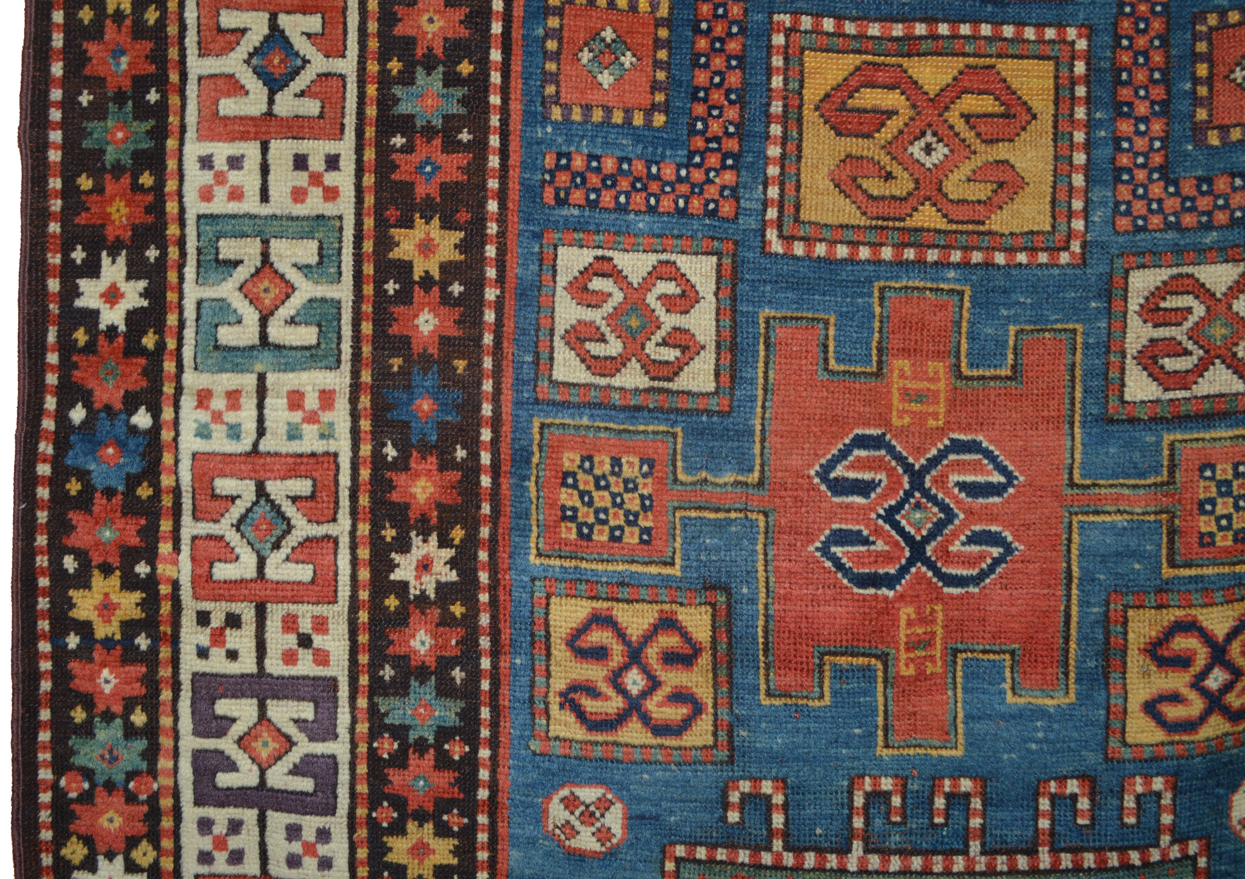 Field and border detail of a 19th century southwest Caucasian Karachoph Kazak rug with a denim blue field and ivory border - Douglas Stock Gallery, South Ntiack, MA, Boston area antique Oriental rugs