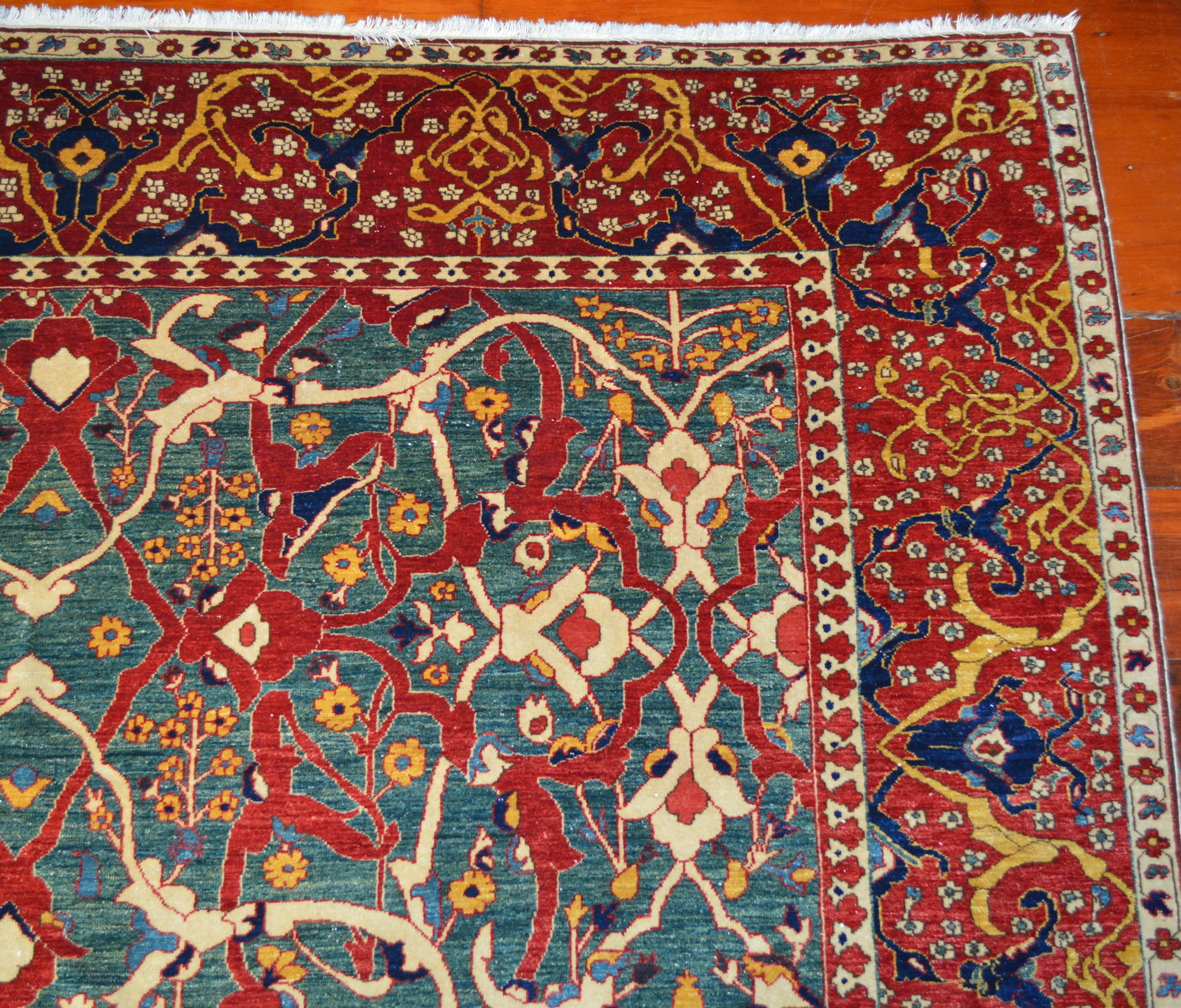 A contemporary hand woven carpet from Azerbaijan with an Arabesque design on a green field. Douglas tock Gallery, Oriental rugs South Natick,MA