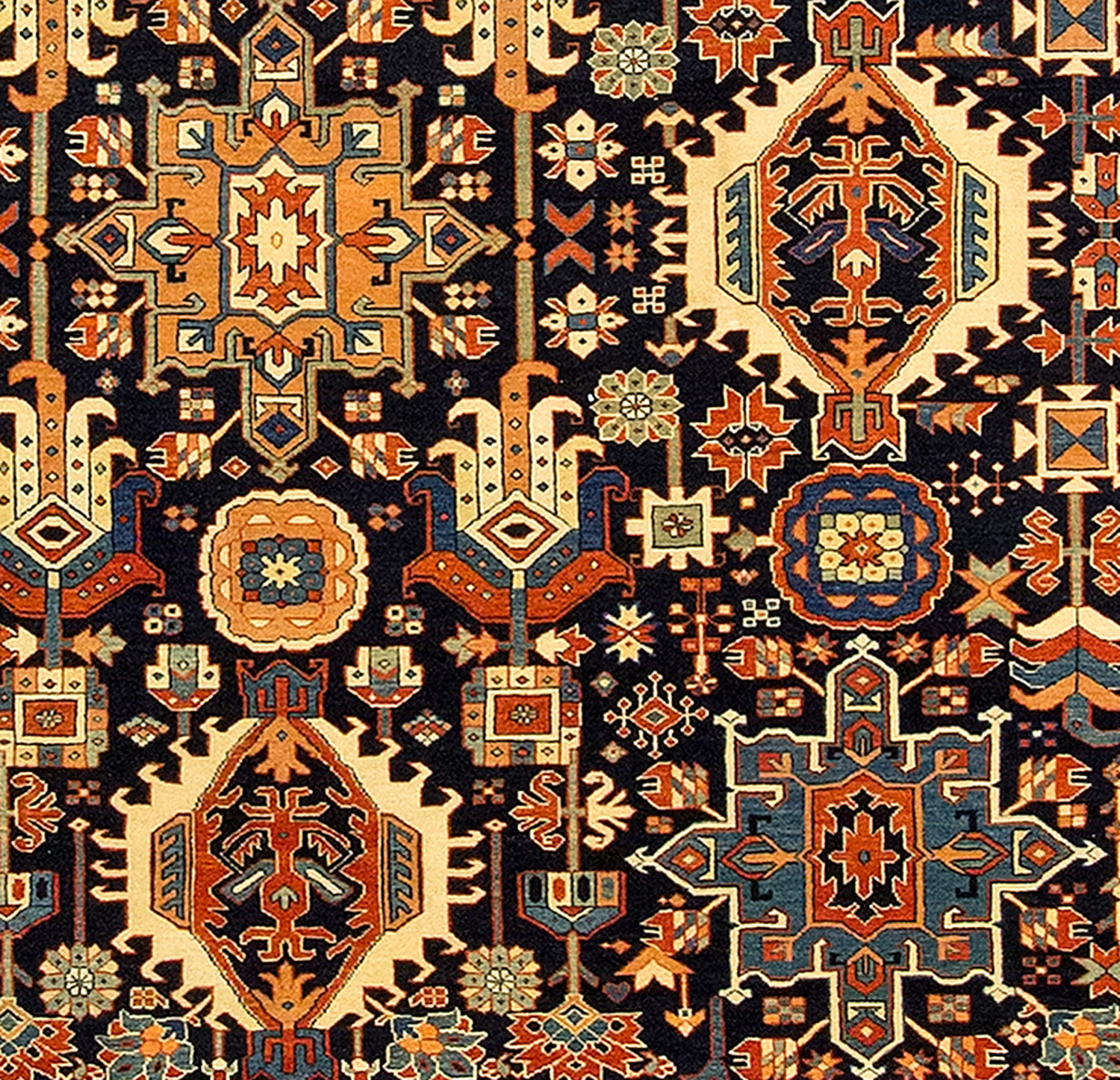 Field detail of a new, hand woven Turkish carpet with a Persian Karaja design of medallions on a navy blue field. Douglas Stock Gallery, antique and new Oriental rugs South Natick,MA, Boston area