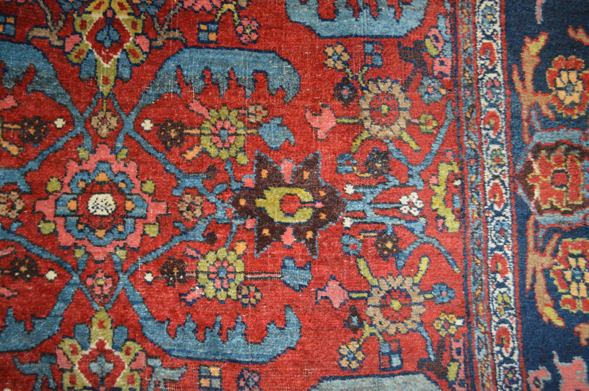 Detail of stylized leaves and flowers on a red field in an antique Persian Bidjar carpet - Douglas Stock Gallery, antique and contemporary hand woven Oriental rugs Boston,MA area -Newton,Wellesley,Natick,MA, Oriental rugs