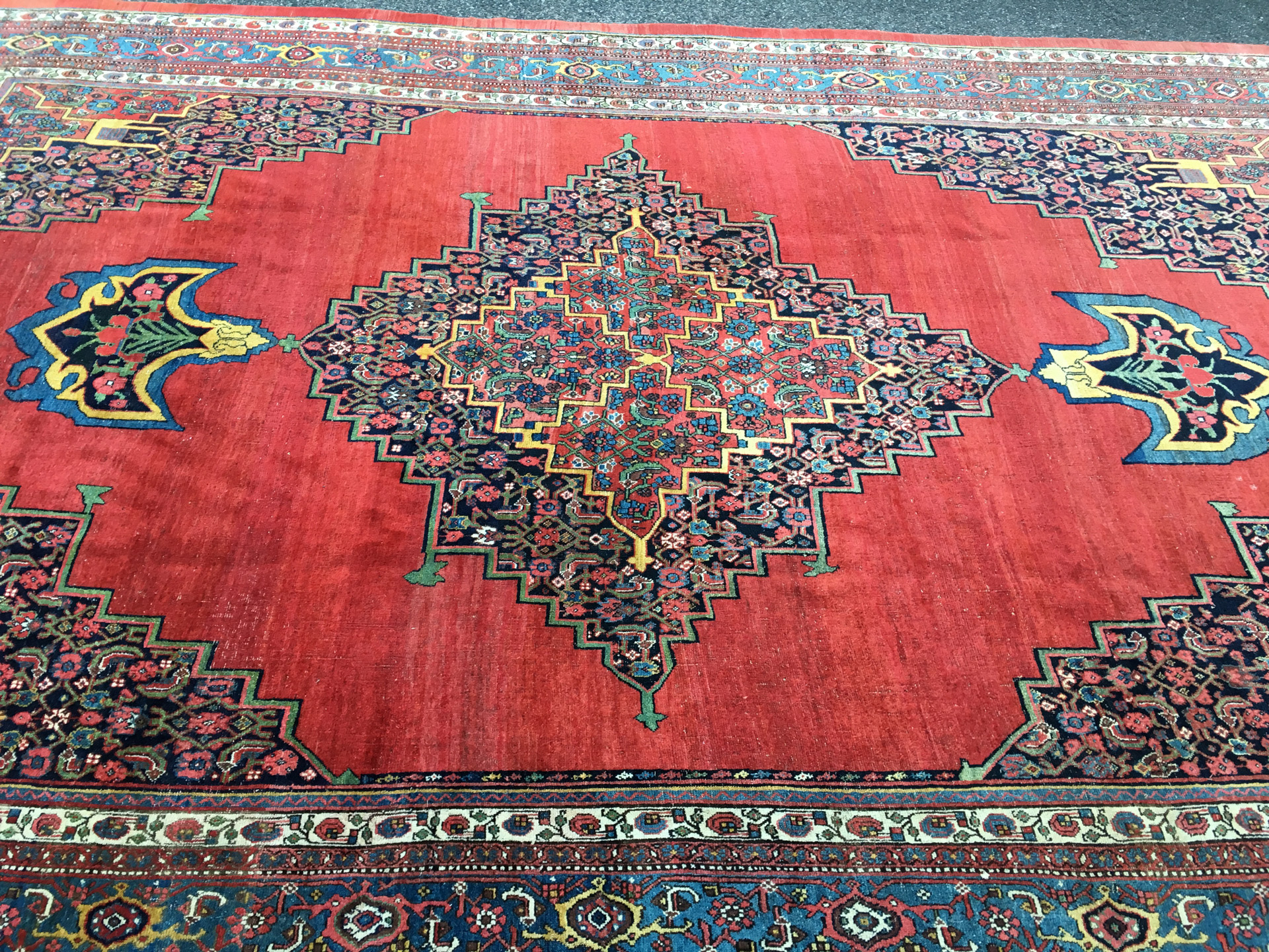 Side view of a 19th century antique northwest Persian Bidjar carpet with a navy, Herati design medallion with Anchor pendants on a red open field - Douglas Stock Gallery, antique Oriental rugs, South Natick , Concord, Weston, Belmont, Brookline, Boston,Ma area antique rugs