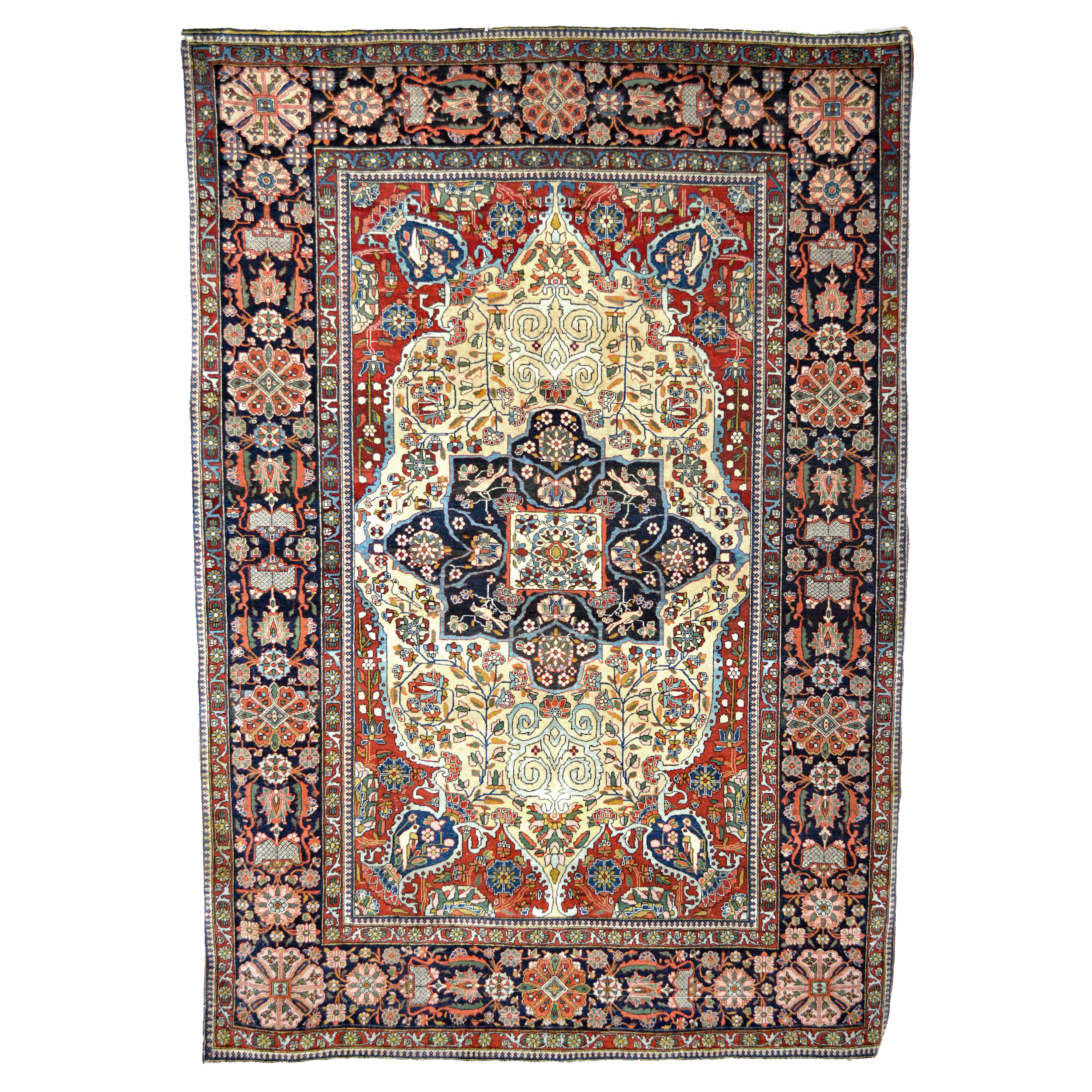 A world class antique Persian Mohtasham Kashan rug with a navy blue medallion on a cream color field that is framed by brick red corner spandrels and a navy blue border. The rug is decorated with floral elements, birds and vases. Douglas Stock Gallery specializes in antique Mohtasham Kashan rugs, antique Persian rugs Boston,MA area, antique Oriental rugs New England
