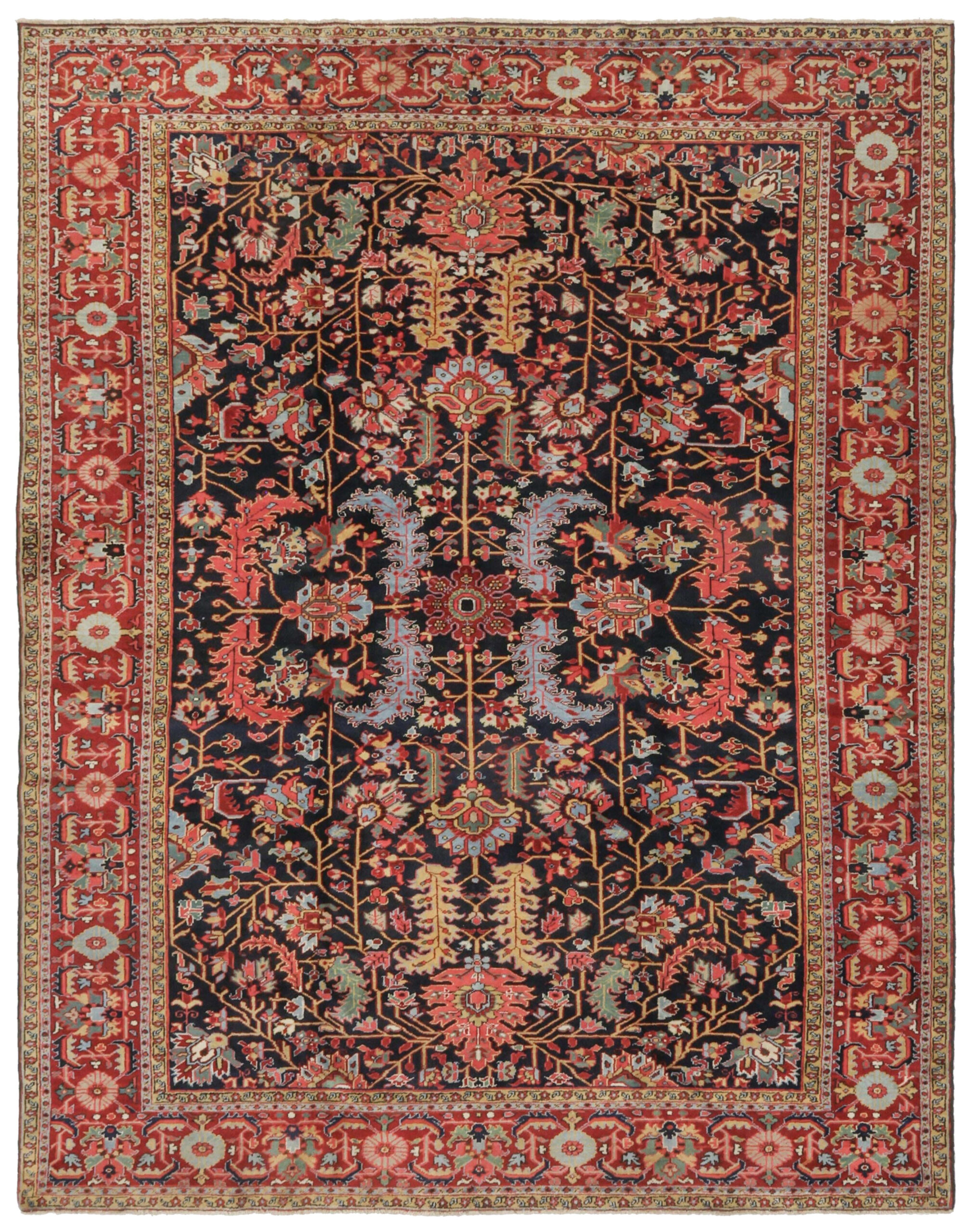 An antique Persian Heriz carpet with coral, light blue and yellow leaves on a navy blue field that is framed by a brick red border. Douglas Stock Gallery offers a wide selection of antique Heriz, Serapi, Karaja and Bakshaish carpets. Antique Persian carpets Boston, Brookline, Newton, Wellesley, South Natick,MA area, antique rugs New England, antique rugs NYC by appointment