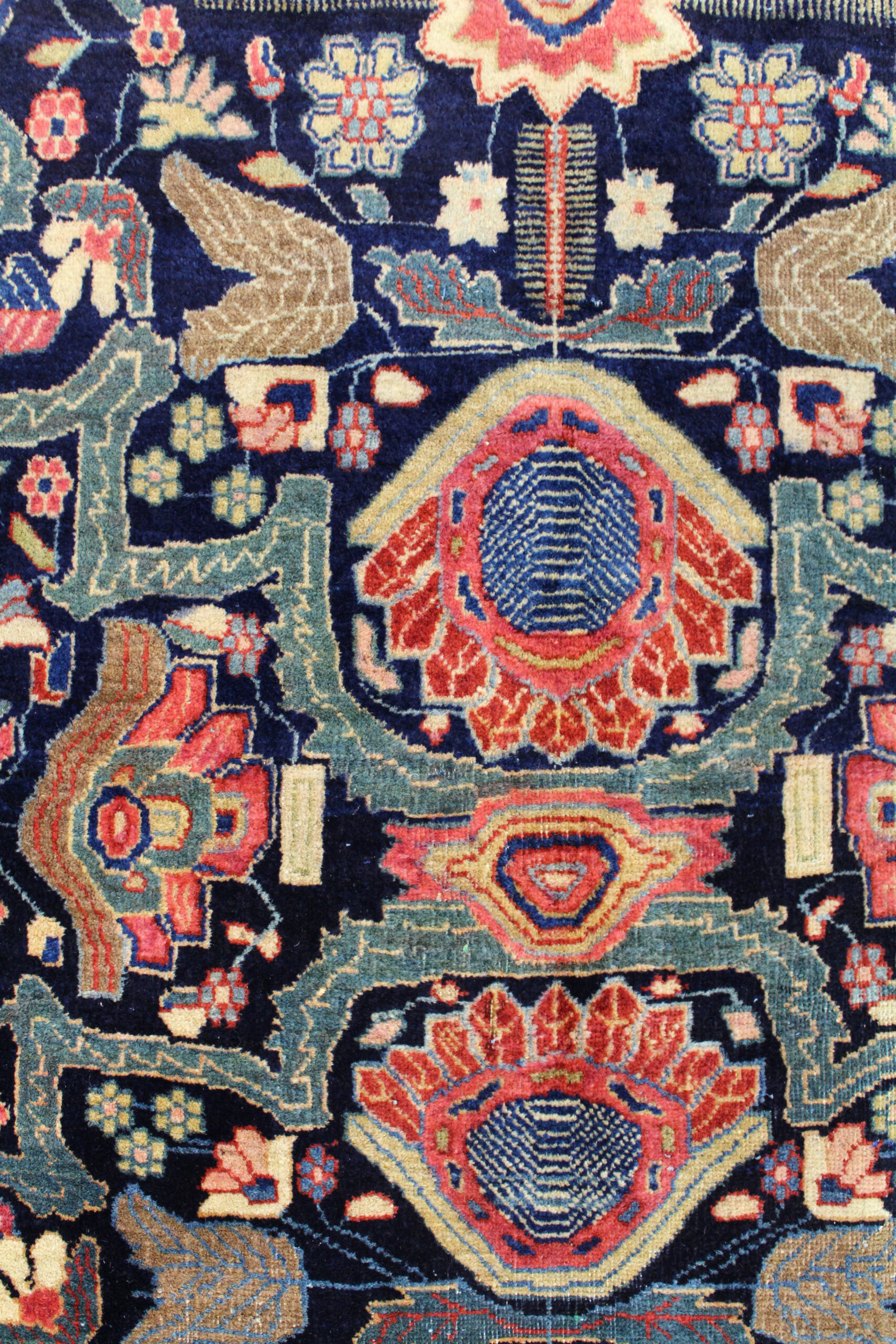 detail of stylized flowers and strapwork from an antique Persian Fereghan Sarouk carpet