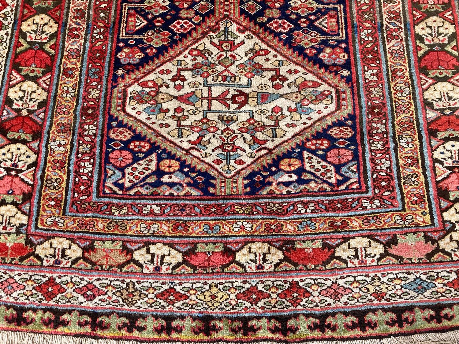 Field, border and medallion detail from an antique northwest Persian rug with a navy field and ivory and brick red borders, Douglas Stock Gallery, antique gallery carpet, antique wide runner rug, antique kelley carpet, antique Oriental rugs Boston,MA area