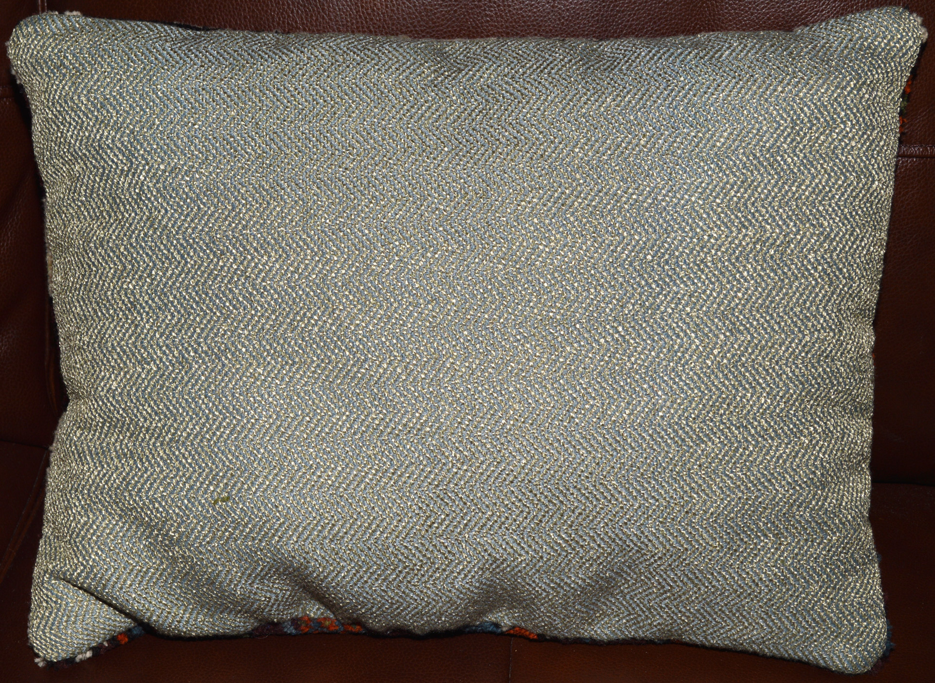 Greenish- Gray herringbone fabric used as backing on some of the Turkish rug pillows