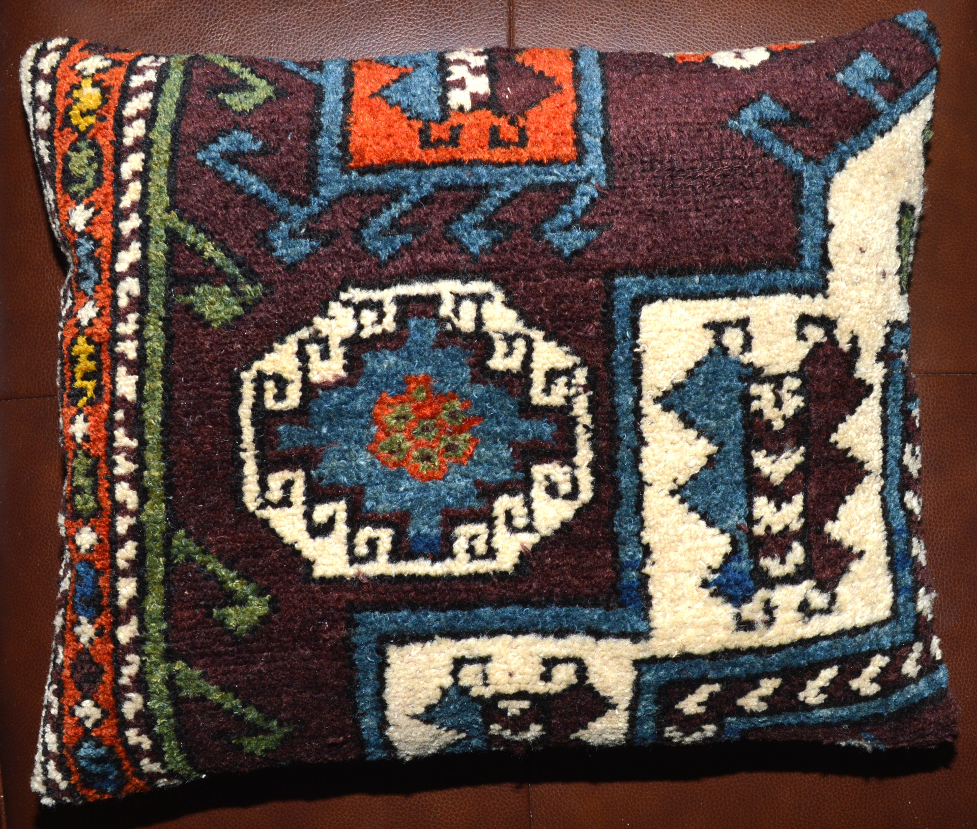 18" x 15" antique Oriental rug pillow made from a fragment of an antique Turkish rug and backed with navy blue velvet. Douglas Stock Gallery, Boston,MA area. We work with private clients, architects and interior designers. Antique rugs, room size carpets, runners, antique rug pillows.