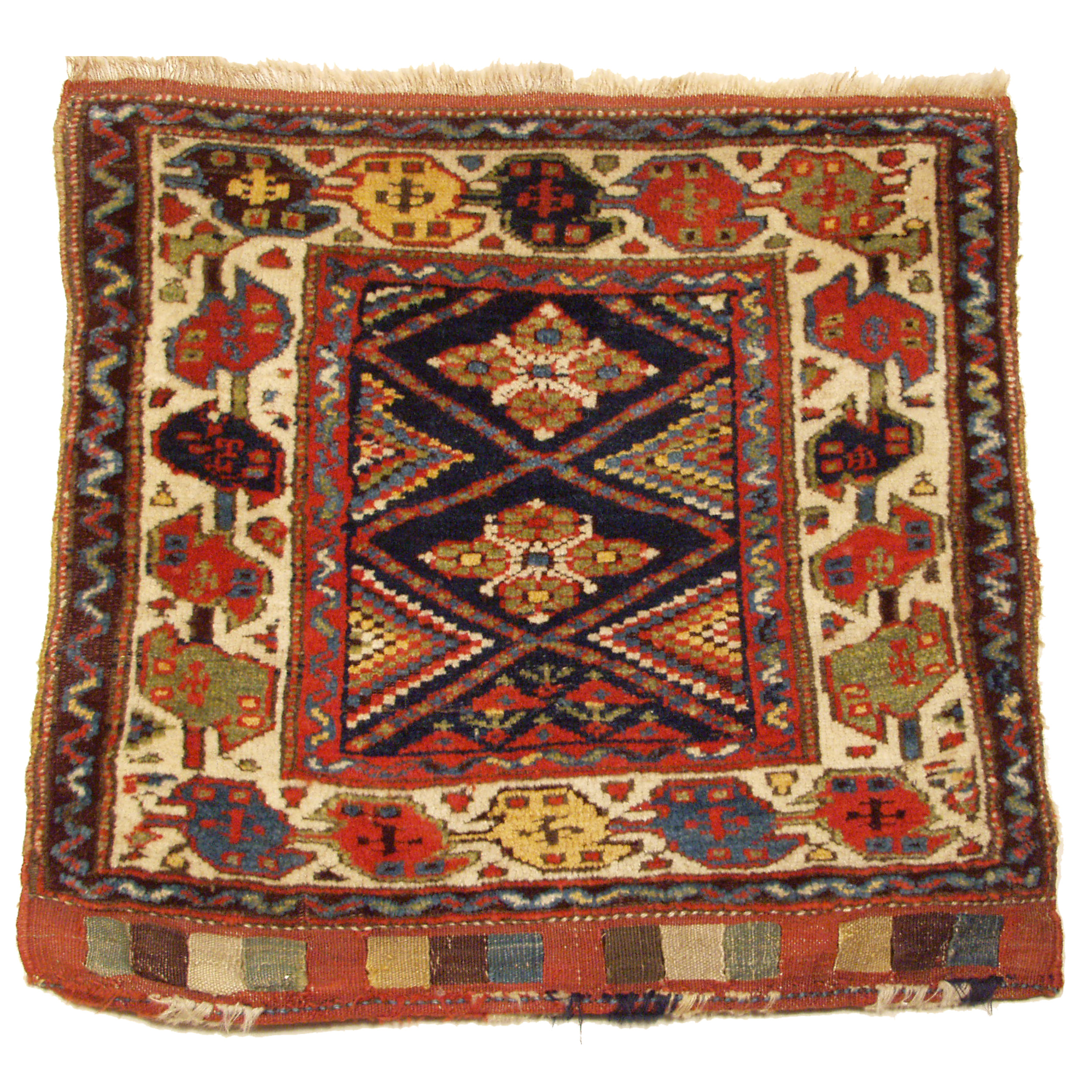 An antique Northwest Persian bag face, probably woven either by the Shah Savan or Kurdish tribes, circa 1880. The navy blue field is decorated with a lattice format and polychrome checkerboard motifs along the sides the field. An ivory "Bird" style border frames the field, circa 1880. Douglas Stock Gallery Antique Oriental Rug Research Archives are an excellent source of information for people interested in learning about antique Oriental rugs, antique carpets and collectable antique Persian and Caucasian bags and bag faces, Douglas Stock Gallery, antique rugs Boston,MA area