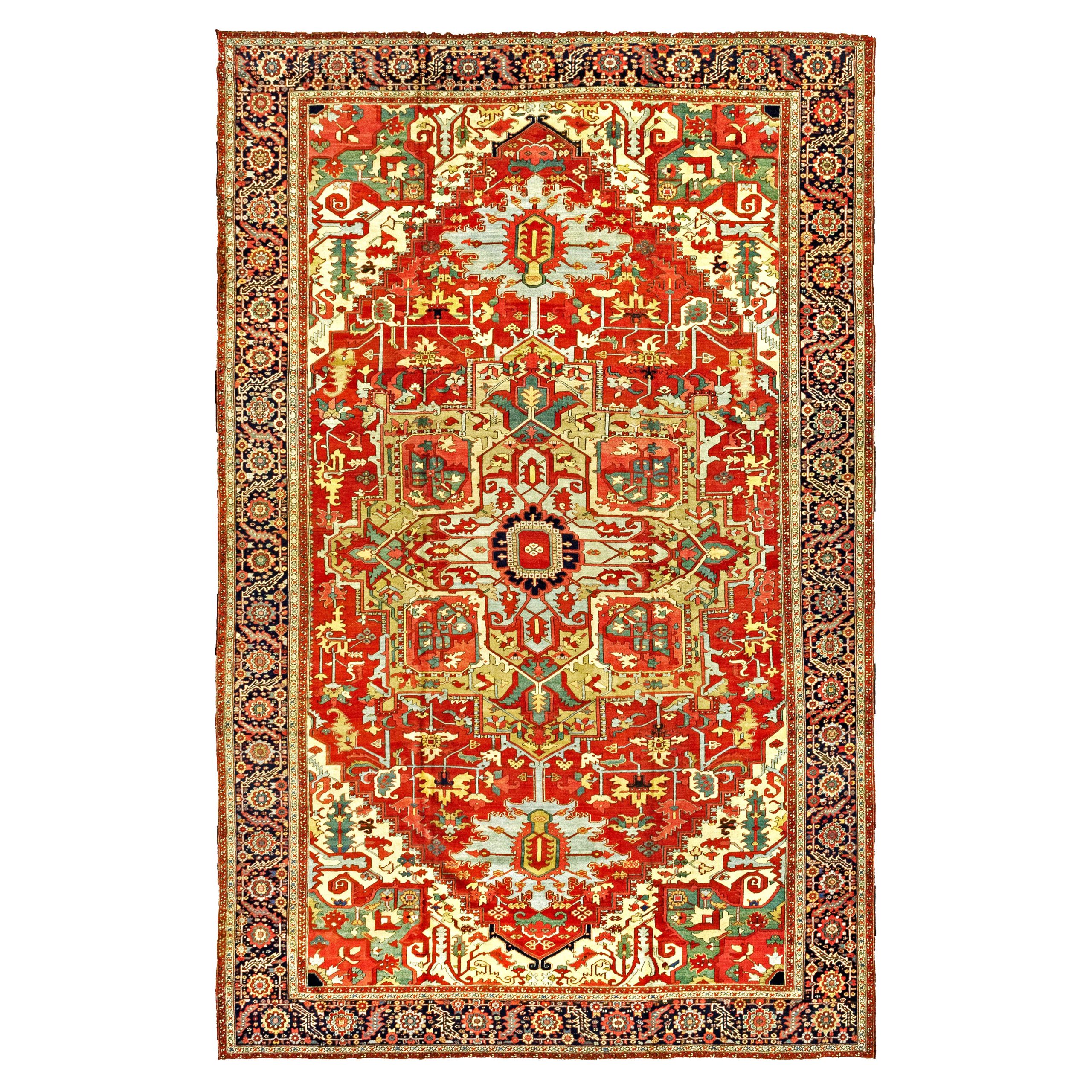 An over size antique Heriz "Serapi" carpet with a greenish-camel color medallion on a terra cotta color field with sky blue pendants. Ivory corner spandrels with green insets and a navy blue border frame the field, northwest Persia, circa 1900. Douglas Stock Gallery features one of New England's finest quality selections of antique Heriz area rugs and room size carpets, including antique Heriz, Karaja, "Serapi" and Bakshaish rugs and carpets.