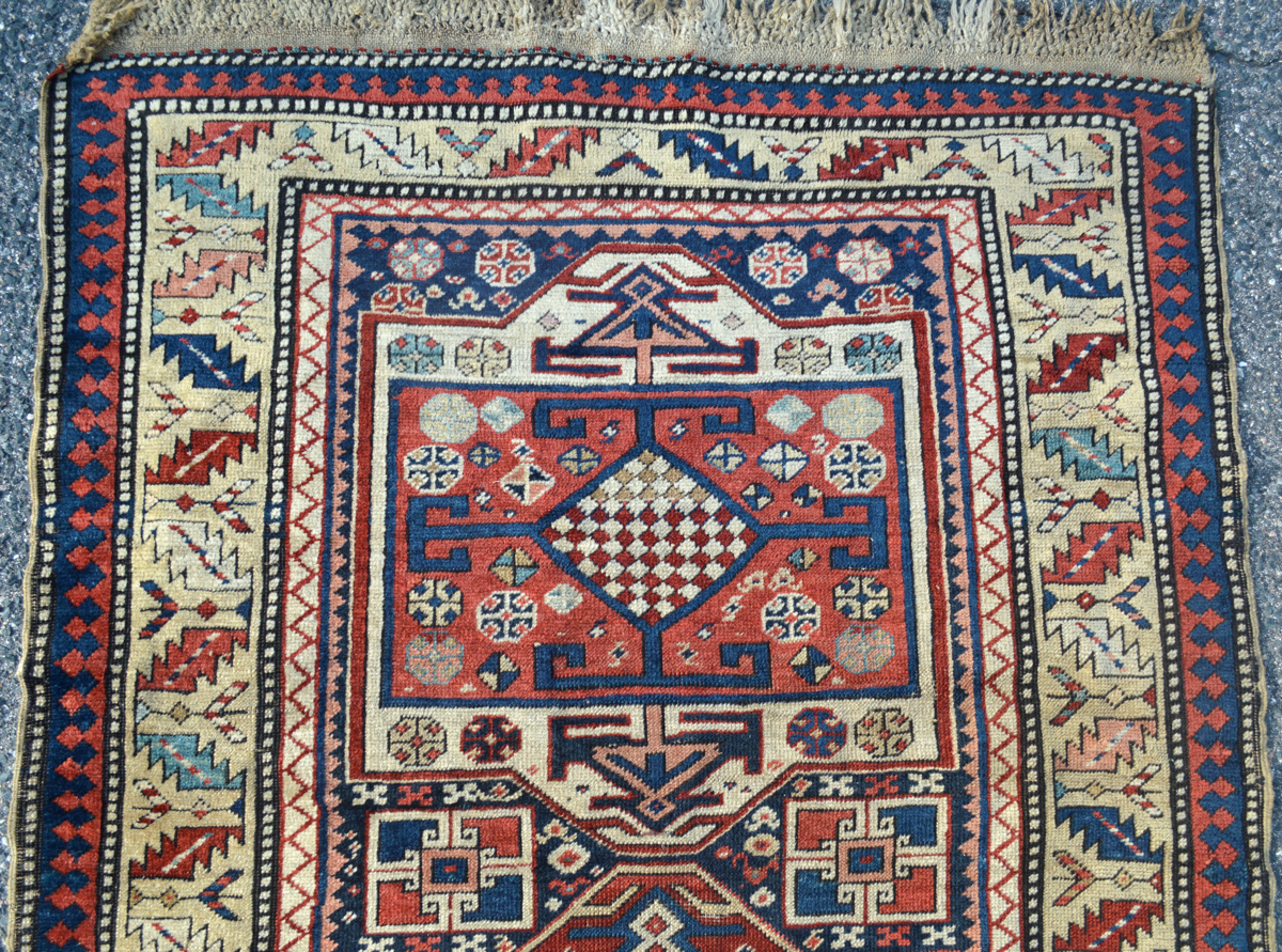 Antique Caucasian Surahani runner rug with a series of medallions on a navy blue field that is framed by a greenish-khaki Leaf and Chalice design border, Douglas Stock Gallery, antique Caucasian rugs, antique tribal rugs, antique decorative rugs Boston, Brookline, Cambridge, Newton, Lexington, Concord, Weston, Wellesley, Needham, South Natick,MA area, antique rugs New England, antique rugs New York, antique rugs Washington,DC