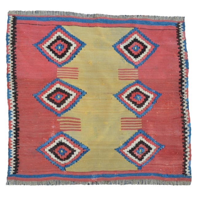 The center panel from an antique Turkish Manastir flat woven kilim Yastik (cushion cover), now made into a pillow backed with light blue velvet.