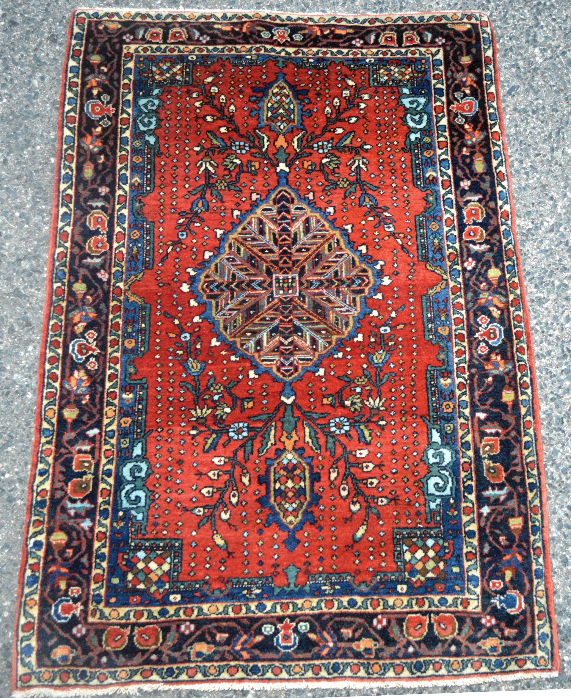 Antique Persian Fereghan Sarouk "mat" or "posit" (a small rug about two feet in width and three feet in length) with a navy blue medallion on a brick red field, circa 1915 - Antique rugs Boston,MA area