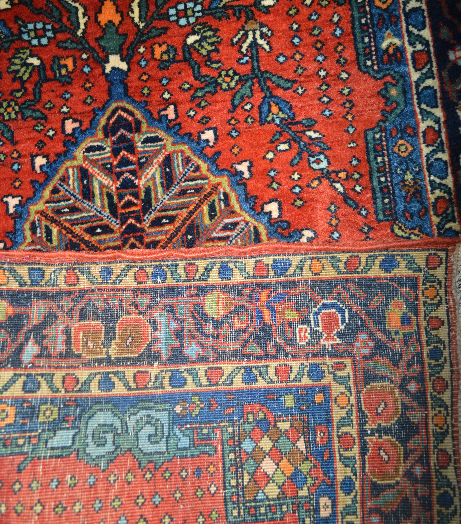 Douglas Stock Gallery antique Oriental rugs Boston,MA area New England - Detail of a fine and densely woven antique Persian Fereghan Sarouk mat (small rugs) with stylized floral motifs on a brick red field, circa 1915