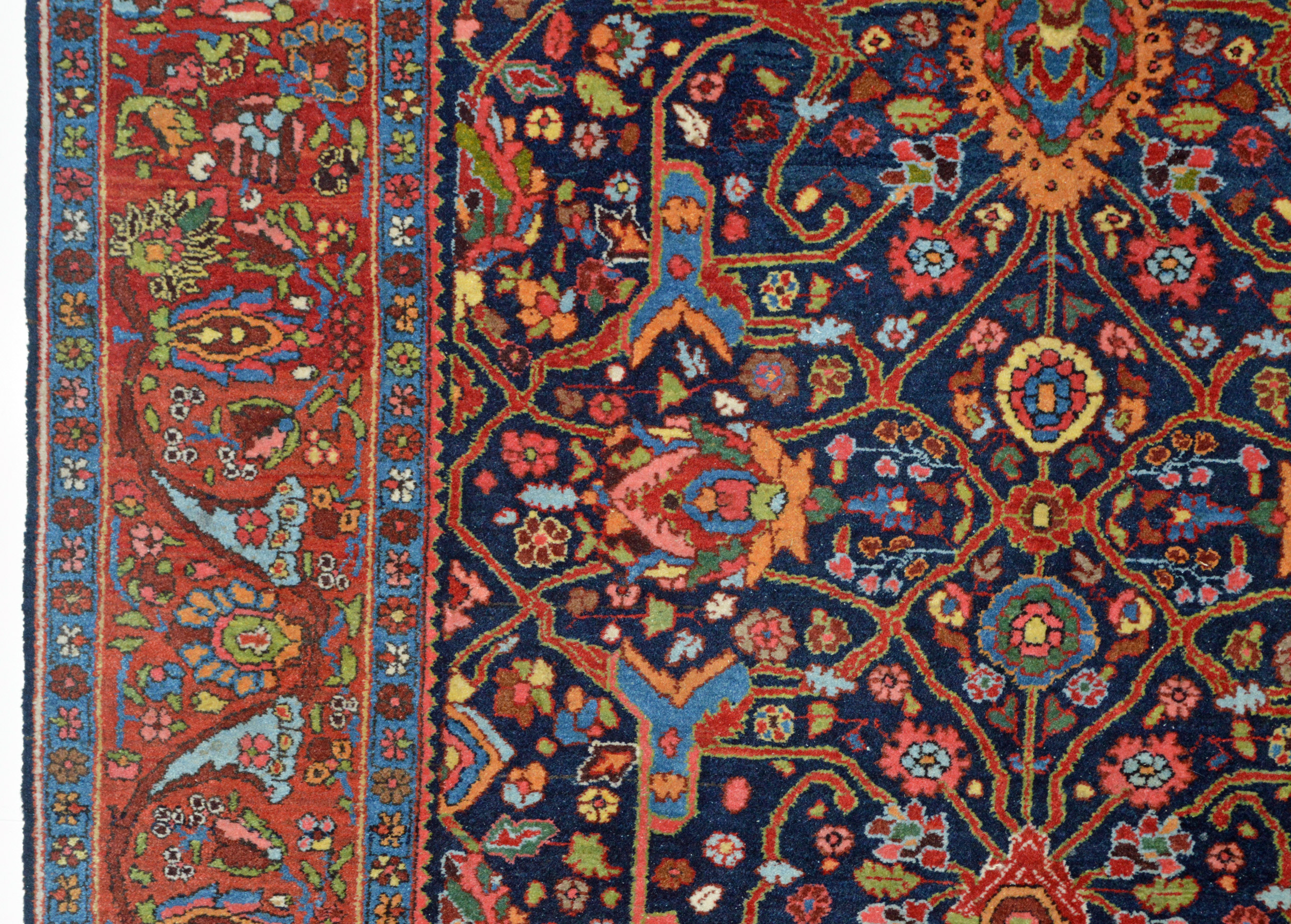 Detail of an antique Persian Bidjar rug with a version of the Split Arabesque design on a navy field that is framed by a brick red border. Douglas Stock Gallery, antique Oriental rugs Boston,MA area, antique rugs New England, antique rugs Natick, Wellesley, Weston,MA area