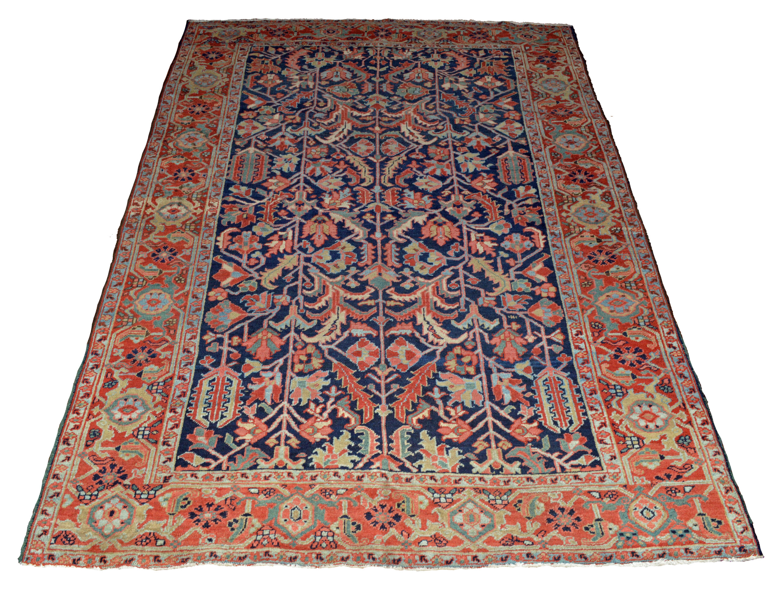 An antique Persian Heriz carpet, circa 1915, with an all-over design of stylized leaves and flowers on a navy blue field that is framed by a red border with the Turtle design. Douglas Stock Gallery is one of America's most selective dealers in antique Oriental rugs. Based near Boston in historic South Natick,MA, Douglas Stock Gallery is open by appointment or chance Monday to Saturday.