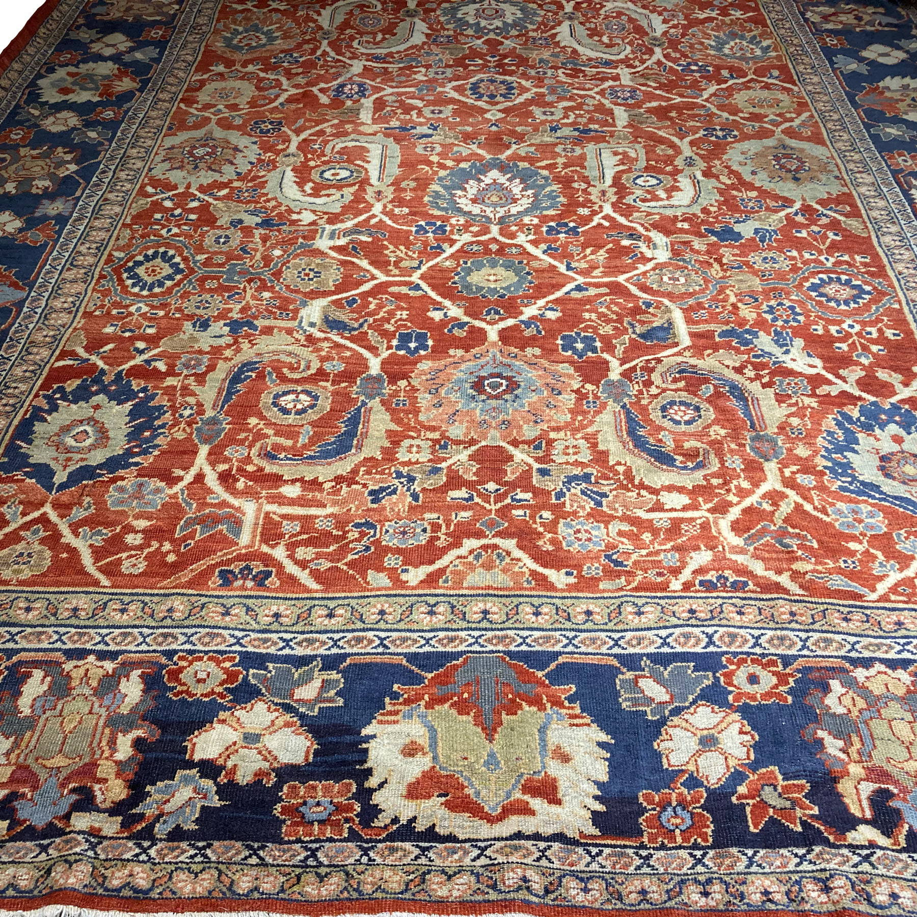 Douglas Stock Gallery features a selection of antique Oriental rugs and room size antique decorative carpets, Boston,MA area. An oversize antique Mahal carpet probably commissioned by the Anglo-Swiss firm Ziegler & Co. in central Persia's Sultanabad province, circa 1900. The brick color field is decorated with large palmettes and leaves and framed by a navy blue border with large palmettes and ancillary stylized floral motifs. Antique carpets Boston, Brookline, Weston, Newton, Wellesley, Needhma, South Natick, Boston North Shore, Boston South Shore, Boston Metrowest antique Oriental rugs.