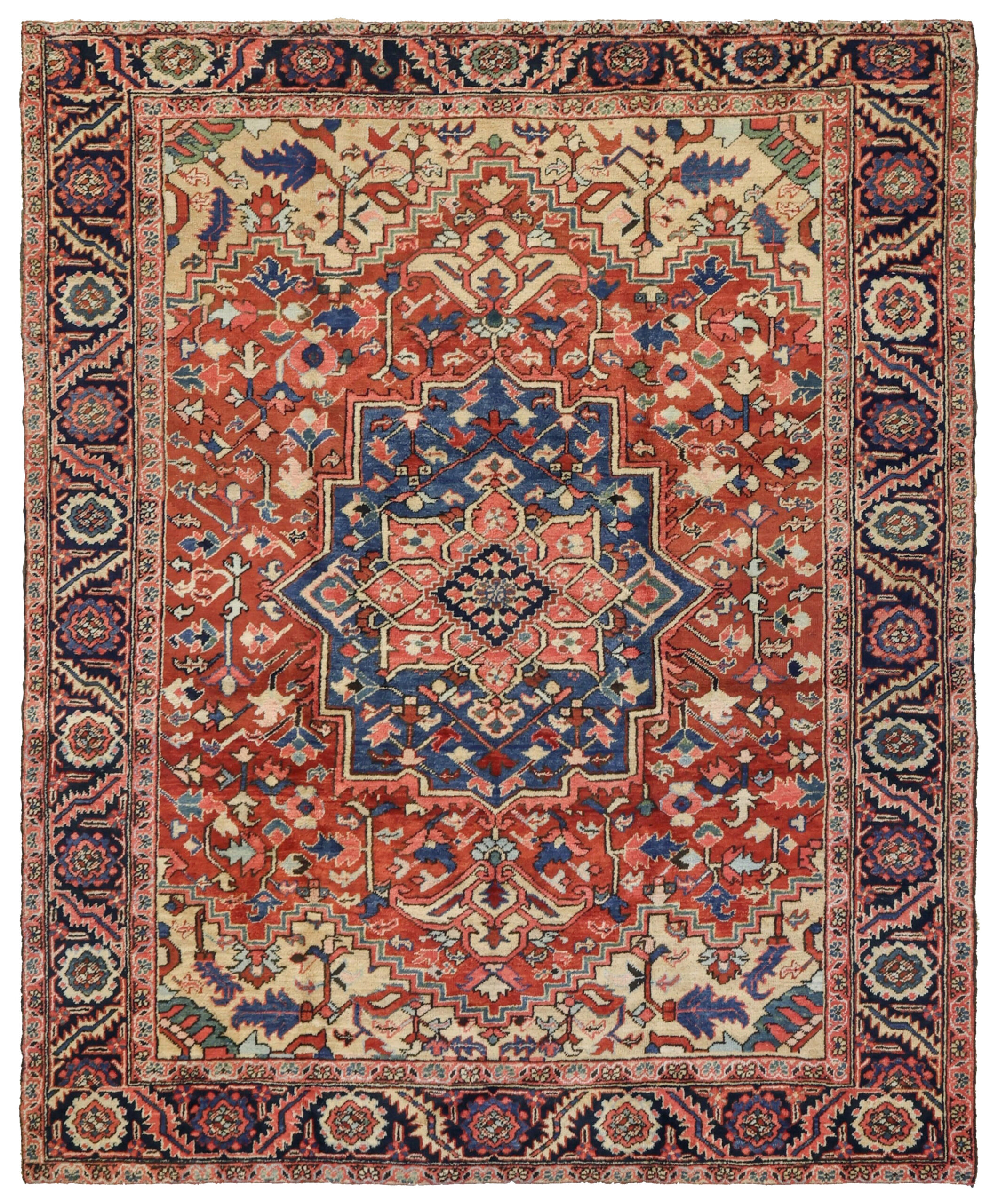 An antique Goravan carpet from the Heriz district in northwest Persia. The denim blue and coral medallion decorates the terra cotta color field which is framed by camel color corner spandrels and a navy blue border. Douglas Stock Gallery, antique Oriental rugs Boston, Brookline, Concord, Weston, Wellesley, Dover, Sherborn, Needham, Natick,MA area