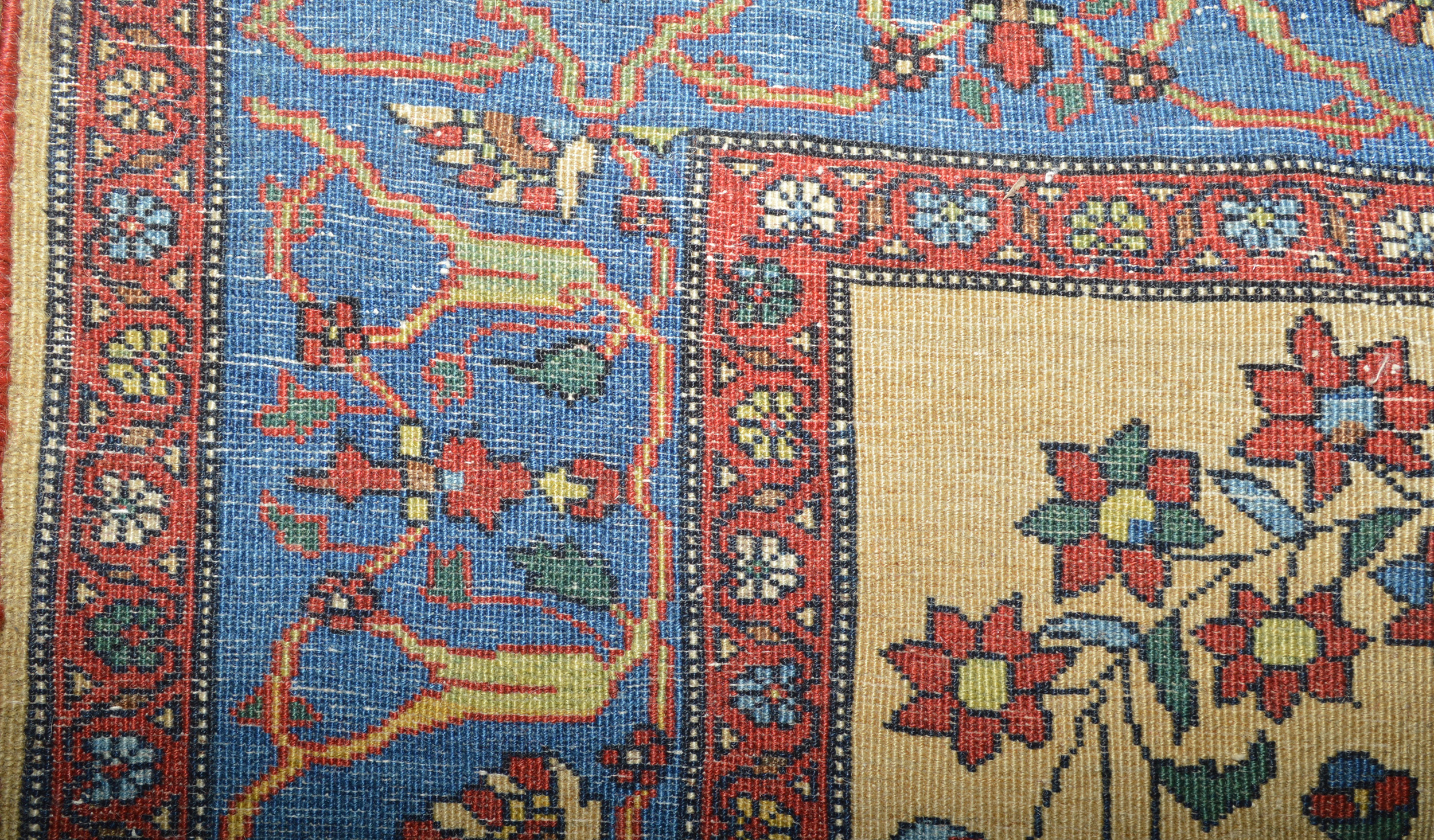 Weave detail from a finely woven antique Persian Fereghan Sarouk rug, circa 1900. The ivory field is decorated with a directional floral design and framed by an abrashed sky blue to mid blue border, central Persia, circa 1900 - Douglas Stock Gallery, antique Oriental rugs Boston,MA area, antique rugs New York by appointment