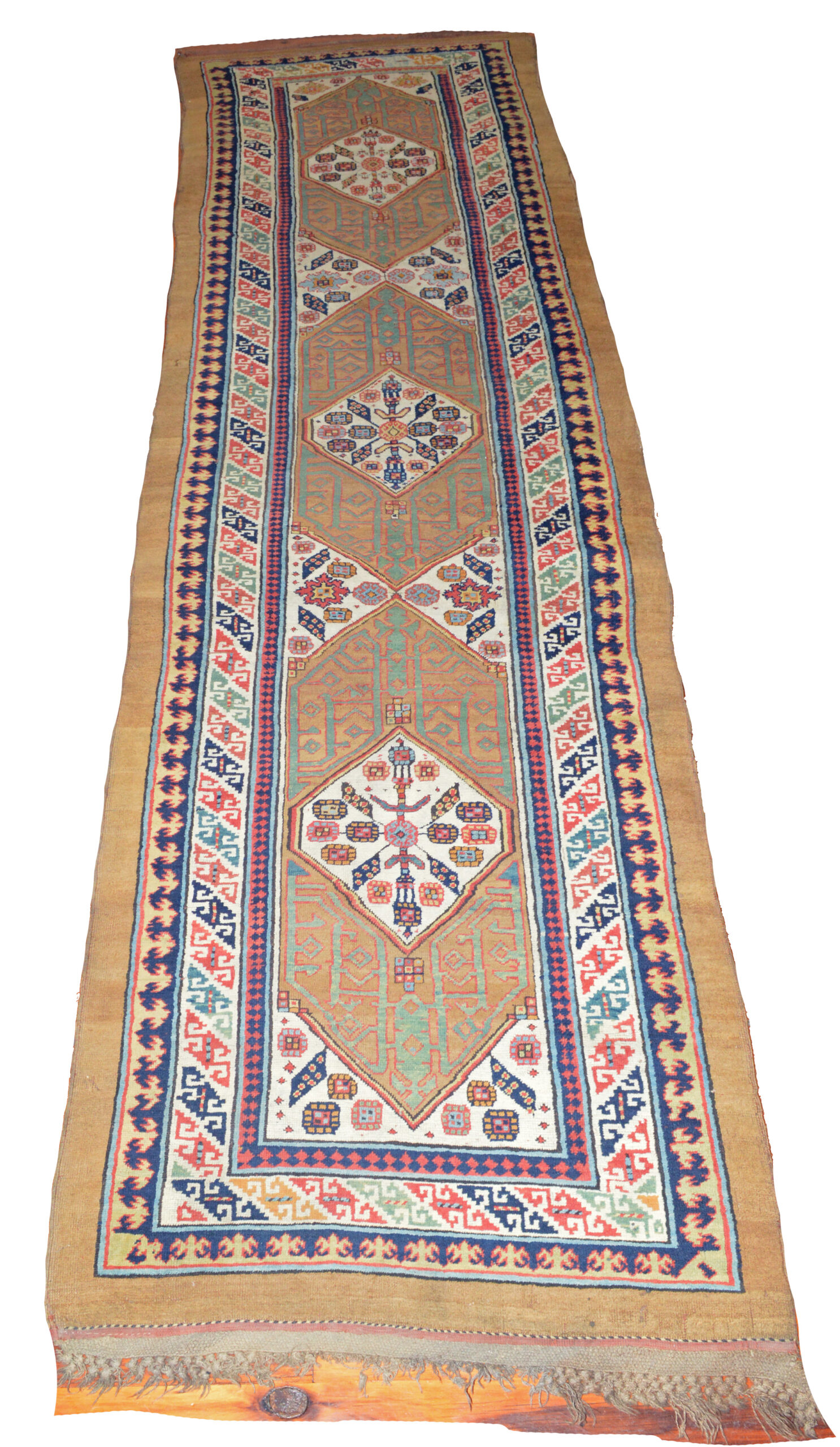 An exceptional antique Persian Serab runner, circa 1880. The camel color field is decorated with ivory medallions and framed by an ivory border with Reciprocal Trefoil guard borders and a plain, camel color outer band. Douglas Stock Gallery specializes in antique Persian village rugs including Serab, Heriz and Bidjar rugs. Antique rugs Boston,MA area