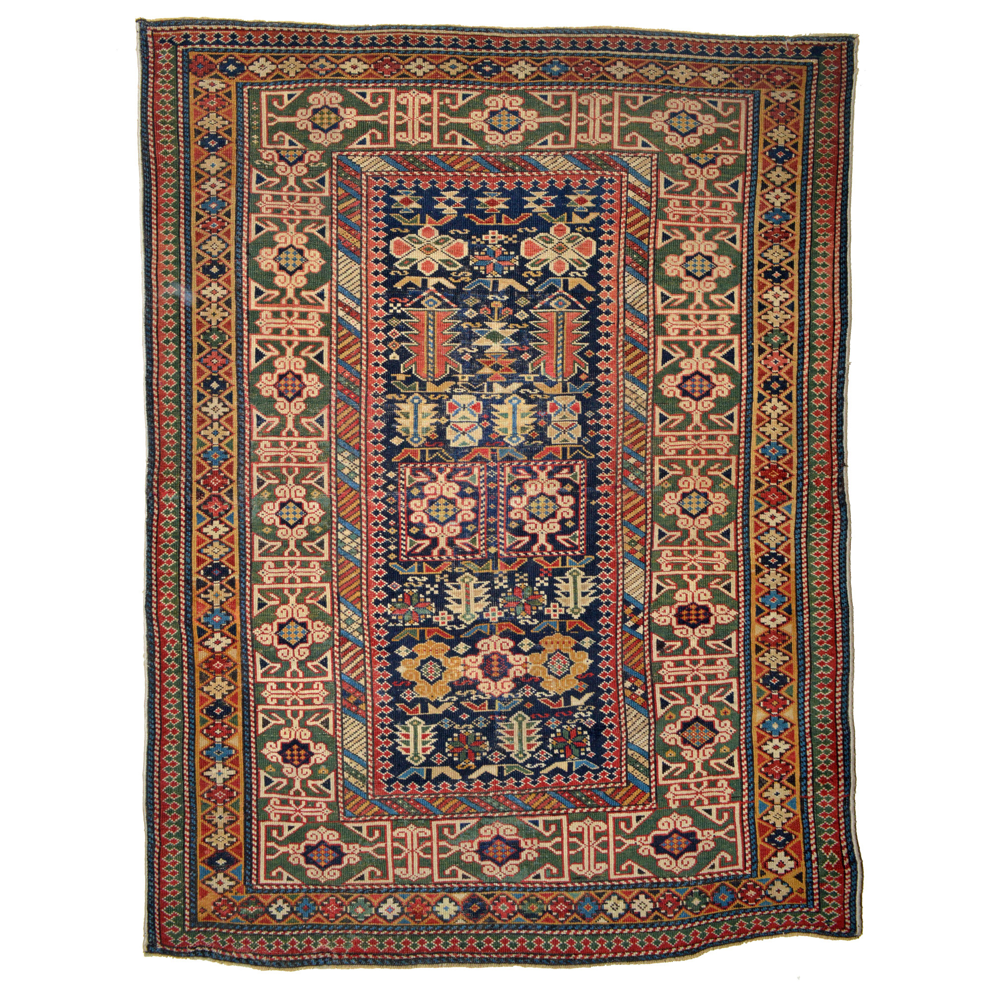 An antique Caucasian Shirvan rug with a navy blue field decorated with stylized leaves and flowers and framed by a green Kufic border, circa 1880. Douglas Stock Gallery offers one of New England's finest quality selections of antique Oriental village and tribal rugs, Boston,MA area, antique rugs Wellesley, South Natick,MA area, antique rugs New England, collectable antique Oriental rugs