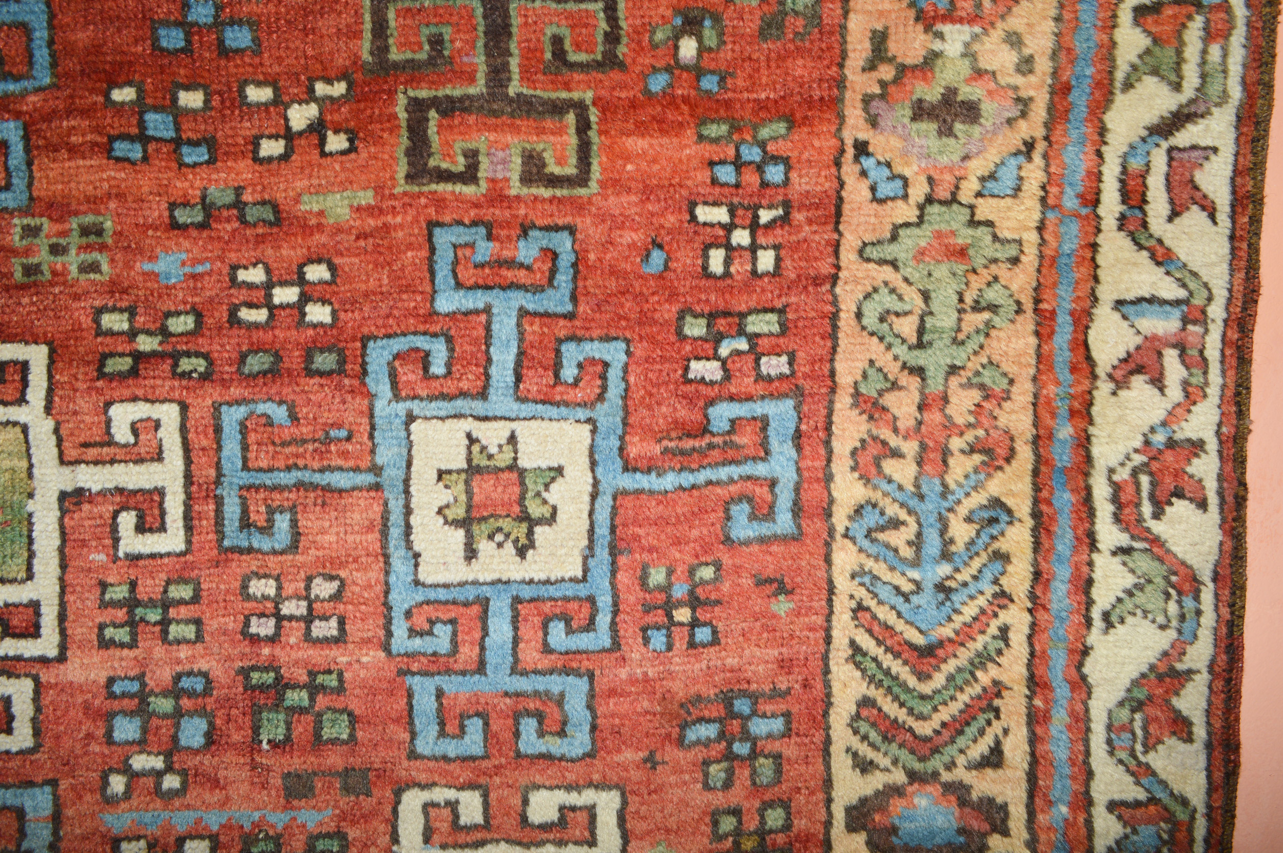 Detail of the field and borders of a 19th century antique Turkish Konya rug. The terra cotta color field is decorated with geometric medallions, circa 1880. Douglas Stock Gallery is one of America's most selective dealers in antique Oriental rugs, antique rugs Boston, antique rugs New York by appointment