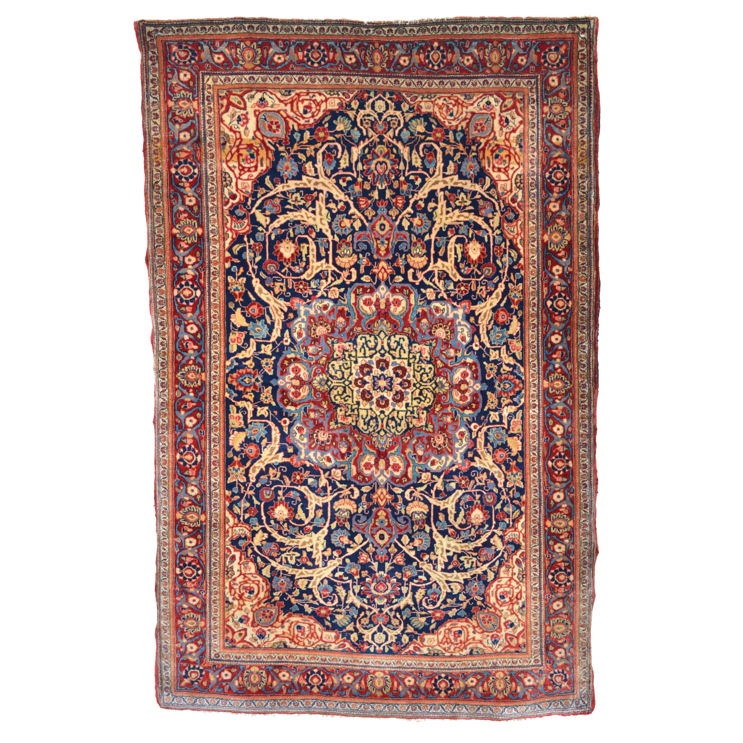 A distinctive antique Persian rug, probable of the Fereghan Sarouk type, central Persia, circa 1915. The navy field is decorated with a crimson medallion and framed by ivory corner spandrels and a crimson border. Douglas Stock Gallery, antique rugs Boston,MA area