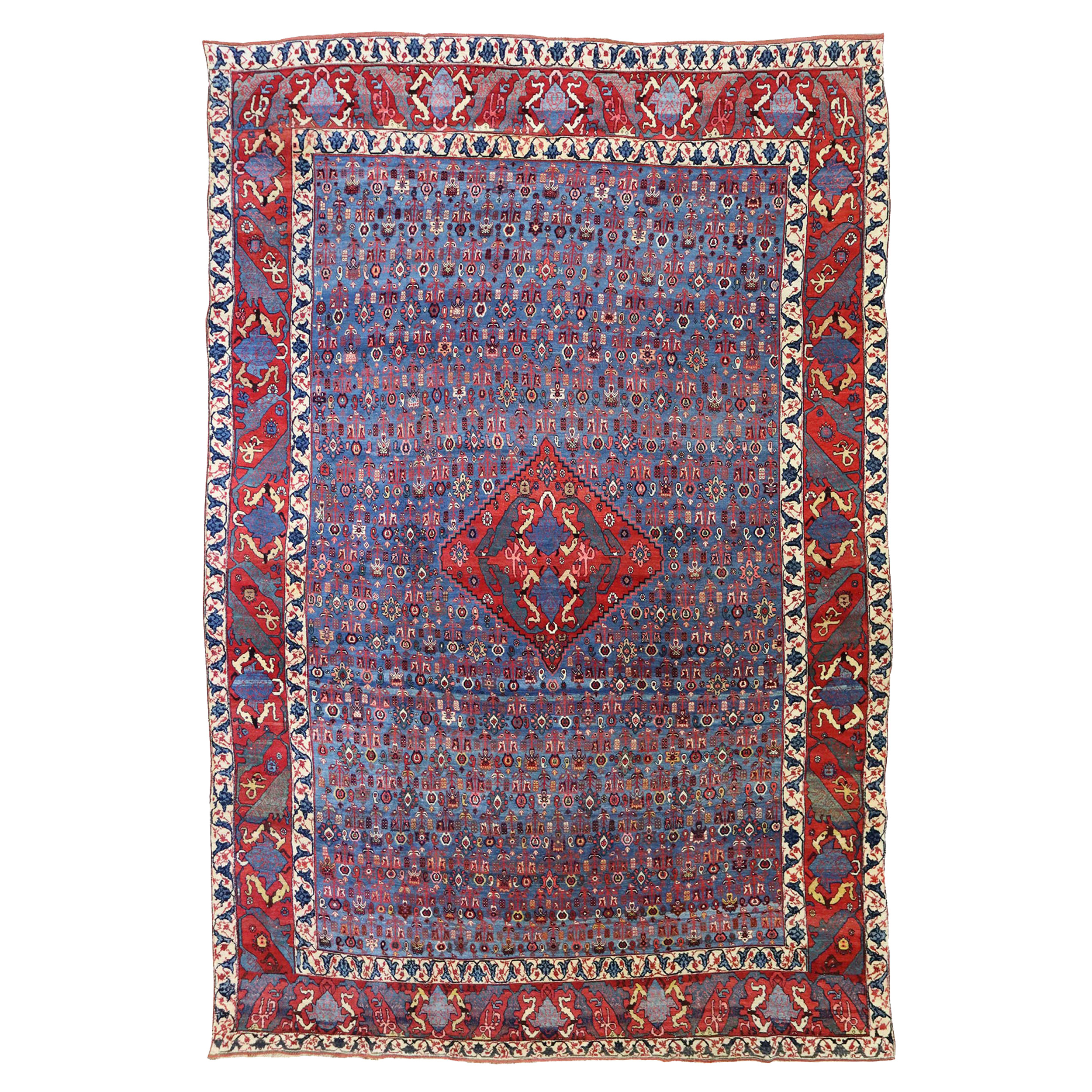 An antique Persian Bidjar (Gerus) carpet with a distinctive design featuring small, stylized flowers on an abrashed mid blue field, circa 1890. Douglas Stock Gallery is one of America's most selective dealers in antique Persian carpets and other types of antique Oriental rugs.