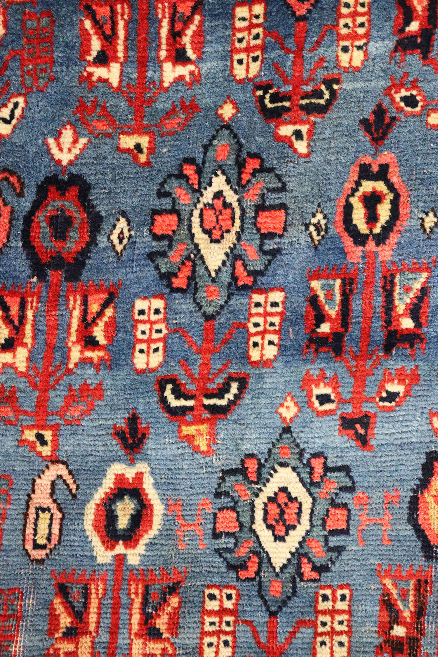 Field detail of an early Bidjar carpet, northwest Persia, circa 1890, with an uncommon field design of small, stylized flowers on a mid blue field. Douglas Stock Gallery, antique Oriental rugs.