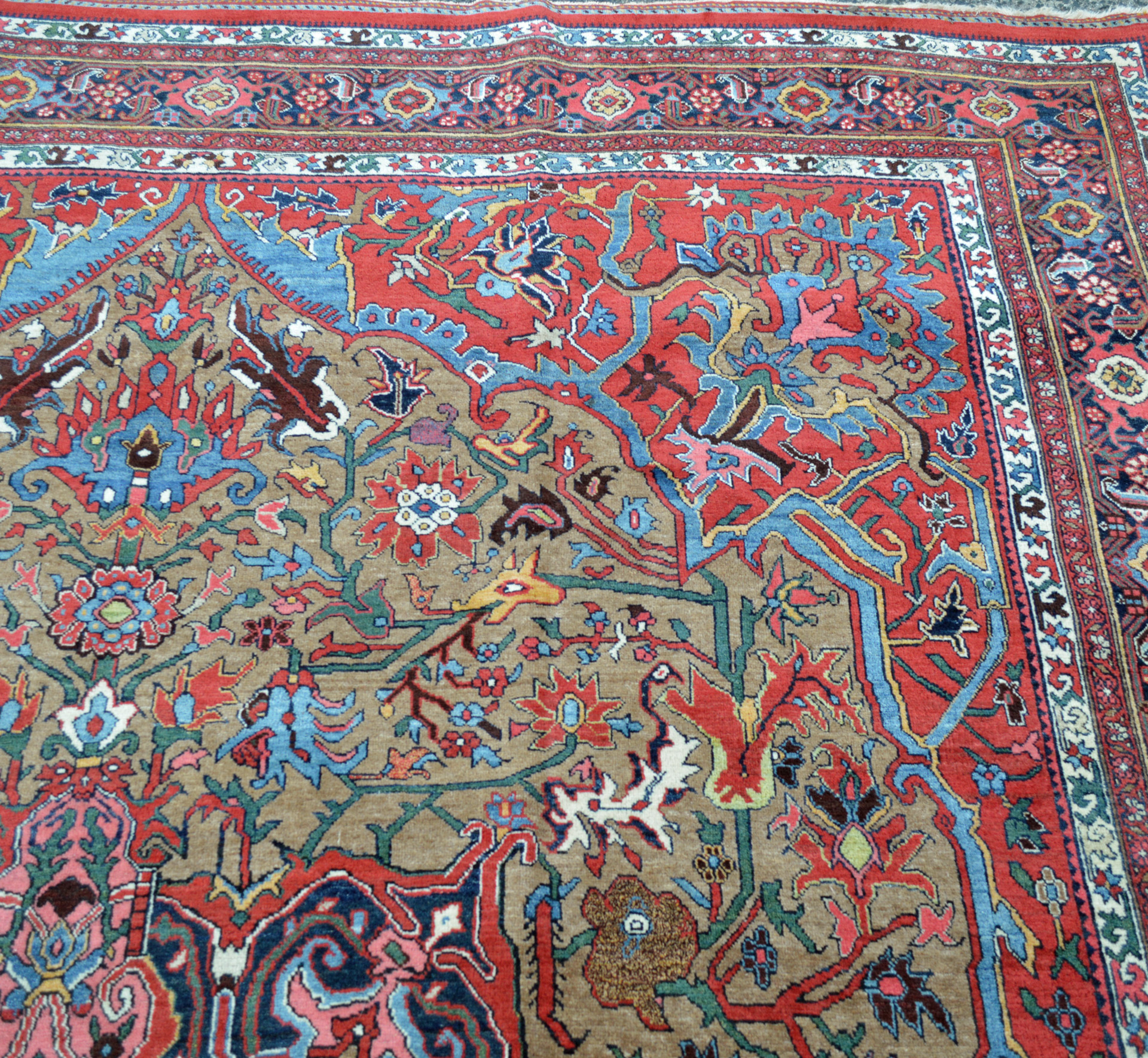 Field, spandrel and border detail from an antique Persian Bidjar carpet, circa 1900, with stylized animals and floral forms on a camel color field, red spandrels and a navy border. Douglas Stock Gallery offers an excellent selection of antique Persian Bidjar rugs and room size Bidjar carpets. Antique rugs Boston,MA area