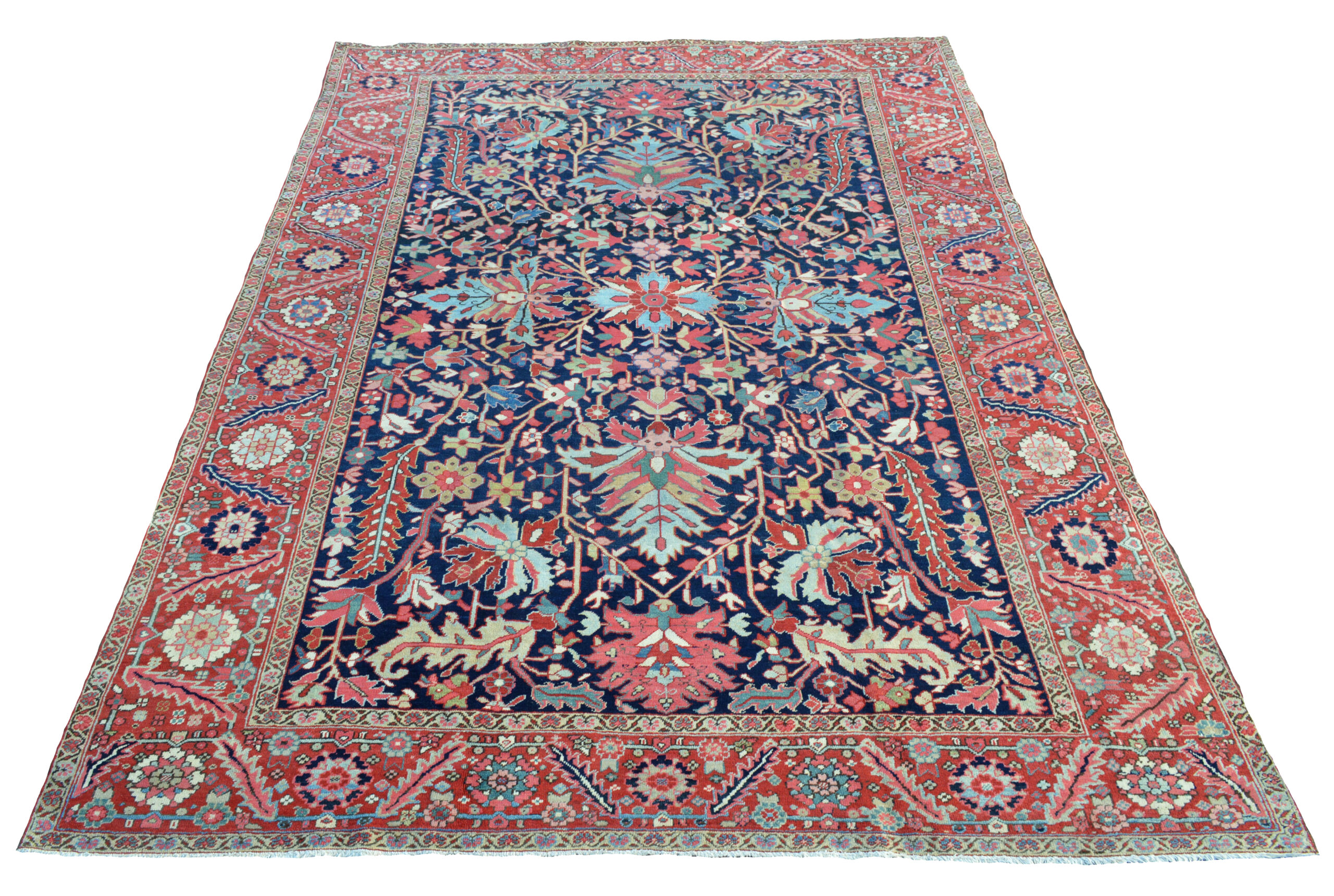 Douglas Stock Gallery offers an outstanding selection of antique Persian Heriz rugs and room size Heriz carpets. An antique Heriz carpet, circa 1910, with large palmettes leaves and stylized flowers on a navy blue field that is framed by a brick red border, circa 1910.