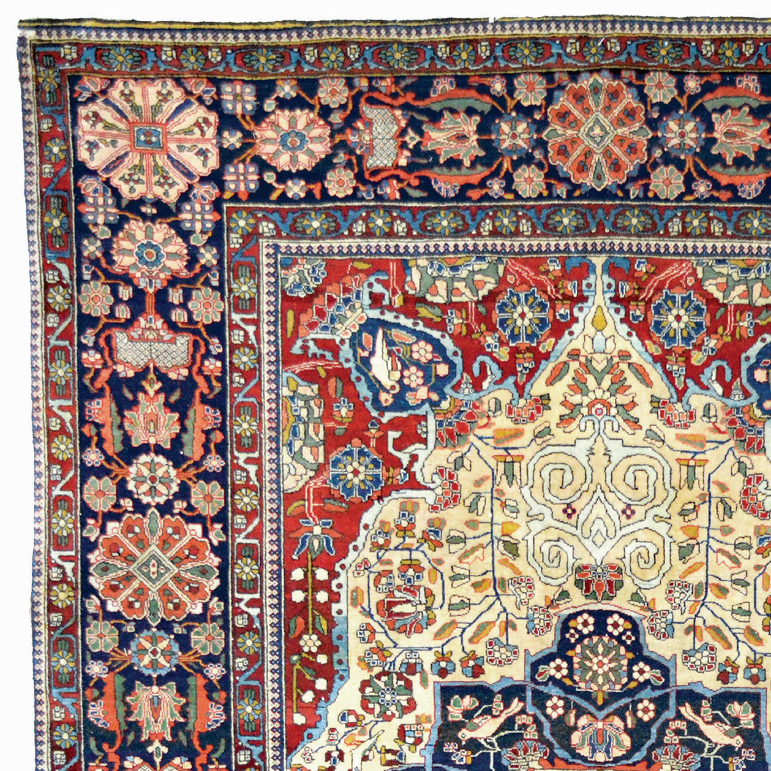 Detail photo of the ivory field, brick red corner spandrels and navy blue border from a late 19th century Persian Mohtasham Kashan rug. Douglas Stock Gallery specializes in antique Mohtasham Kashan rugs.