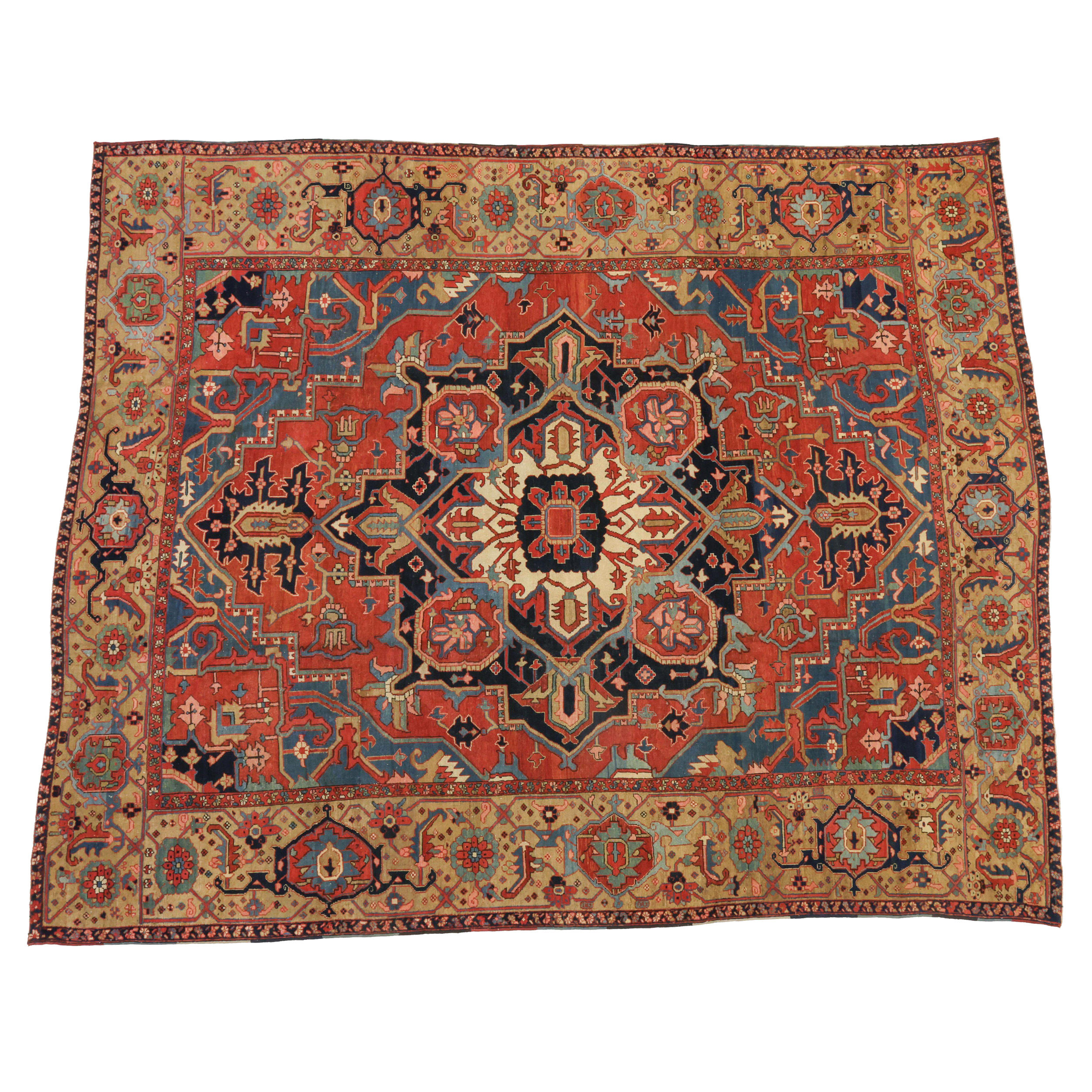 A late 19th century antique Persian Karaja carpet of the type often colloquially referred to as antique "Serapi" carpets. The salmon color field is decorated with a navy blue and ivory medallion and framed by mid blue corner spandrels and a "Turtle" design border of grand scale, northwest Persia, circa 1890. Boston,MA area based Douglas Stock Gallery is one of America's most selective dealers in antique Oriental rugs and specializes in antique carpets from the Heriz area in northwest Persia, especially the earlier Heriz, Karaja and Bakshaish carpets.