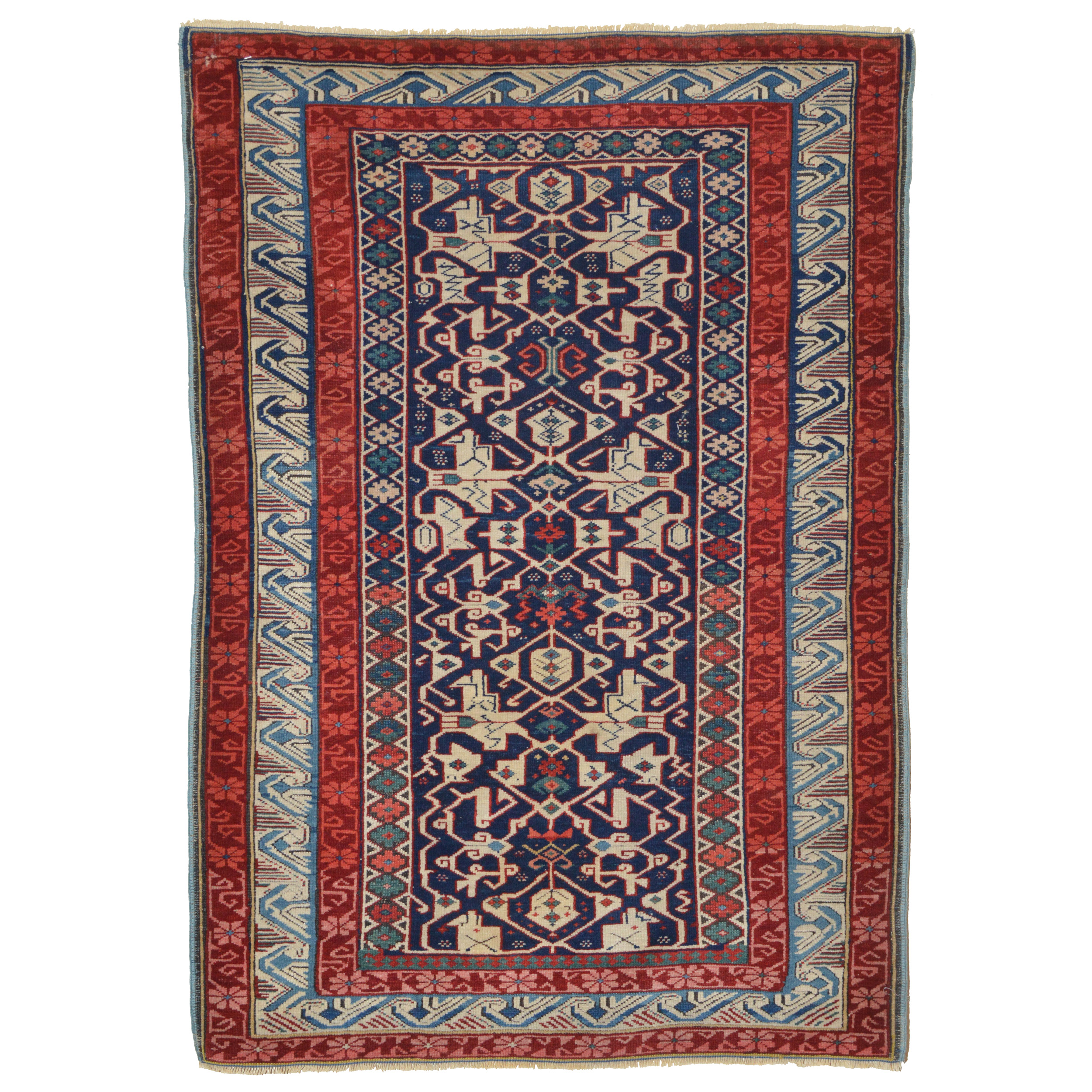 Antique Caucasian Seychour Kuba rug with a navy blue field that is framed by an ivory "running dog" or "wave" border, circa 1890. Douglas Stock Gallery, antique Oriental rugs Boston,MA area