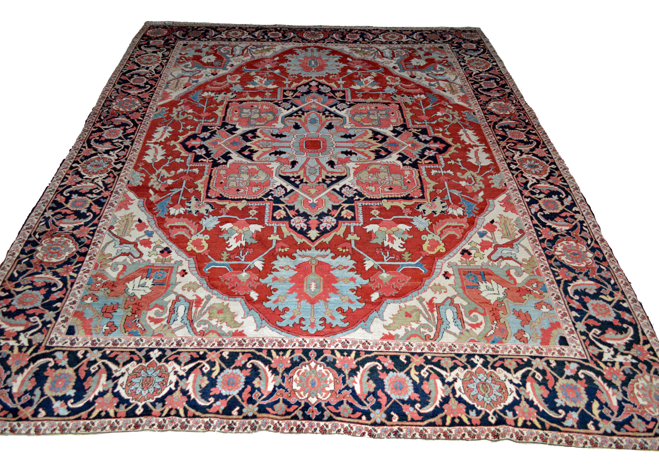 An antique Heriz carpet with a navy medallion on a brick red field that is framed by ivory corner spandrels and a navy blue border, northwest Persia, circa 1900. Douglas Stock Gallery offers a selection of small rugs and room size carpets and runners from from various villages in the Heriz area in northwest Persia including Heriz, Karaja, Bakshaish and Goravan. Antique Persian carpets Boston,MA area, antique Persian carpets New York by appointment, antique Persian carpets Washington DC / Maryland / Virginia area by appointment, antique Persian carpets New England, antique Persian carpets Massachusetts