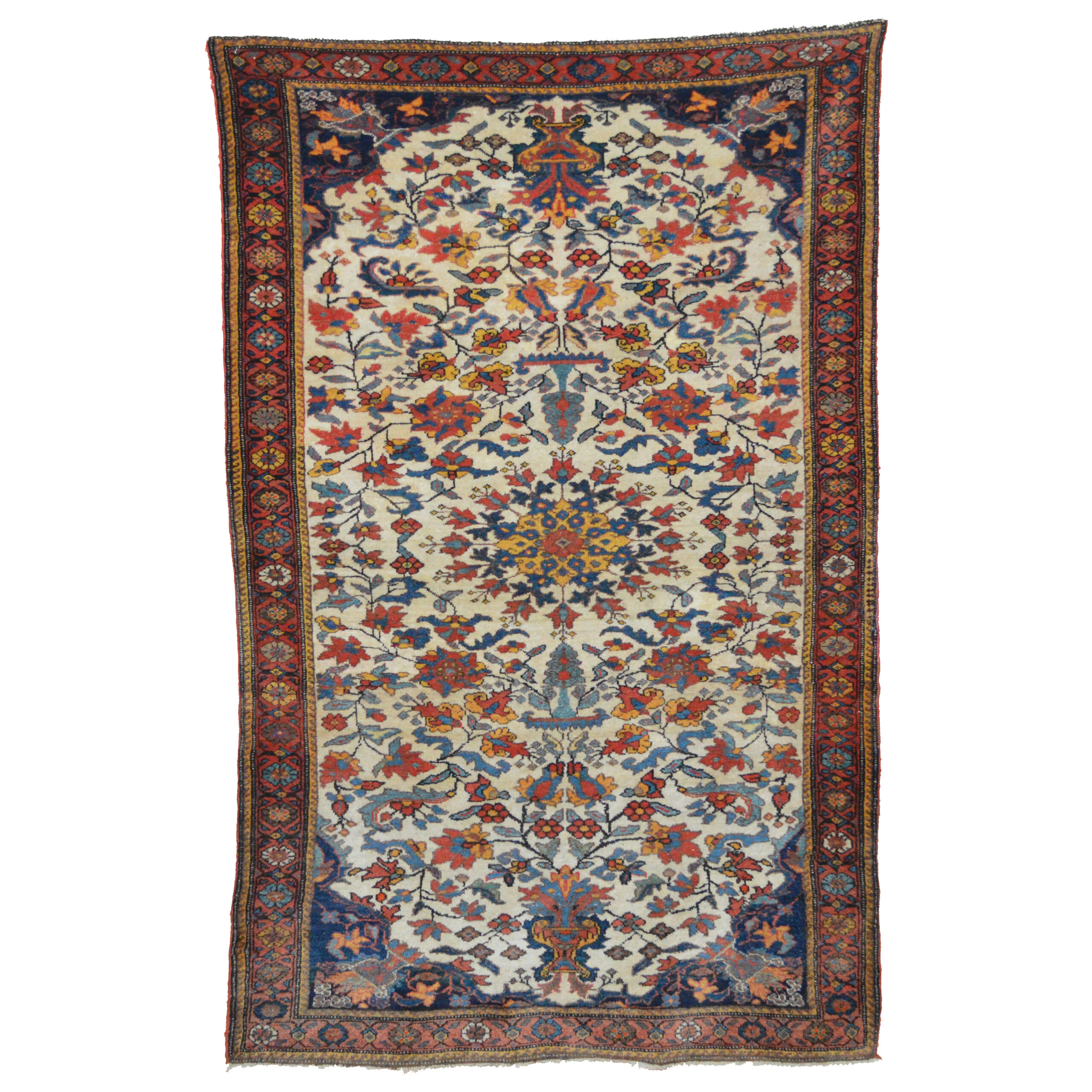 Antique Bakhtiari rug with a floral design on an ivory field around a yellow central flowerhead and framed by a red border, south Persia, circa 1920. douglas Stock Gallery, antique tribal rugs