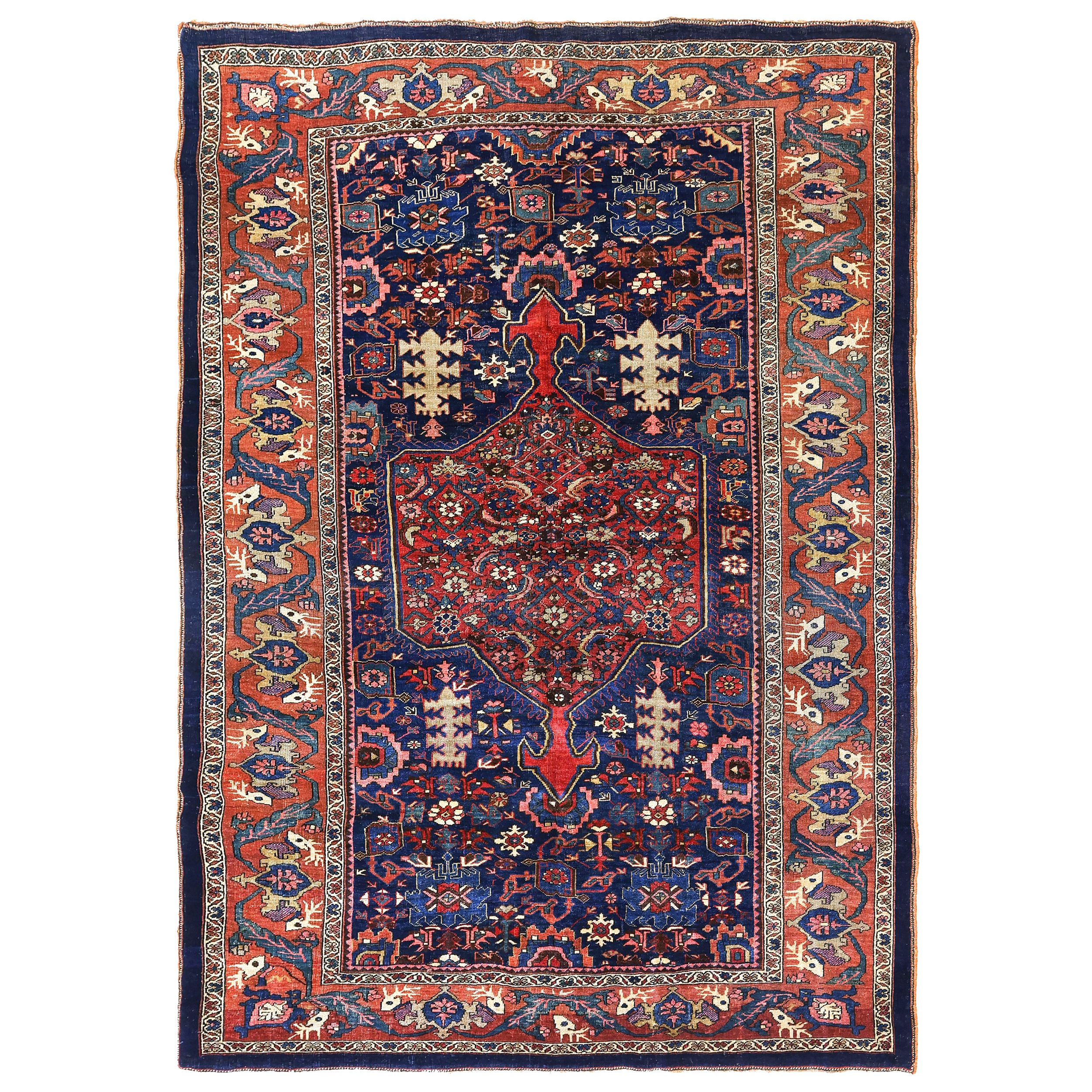 Antique northwest Persian Bidjar rug, Kurdistan province. The navy field contains a rose color medallion and is decorated with the classic Harshang design of palmettes and leaves. A very uncommon and beautiful feature of this rug is the Deer Head format border. Douglas Stock Gallery specializes in antique Bidjar rugs and other antique Kurdish rugs, carpets , runners and bags. Antique Bidjar rugs Boston,MA area