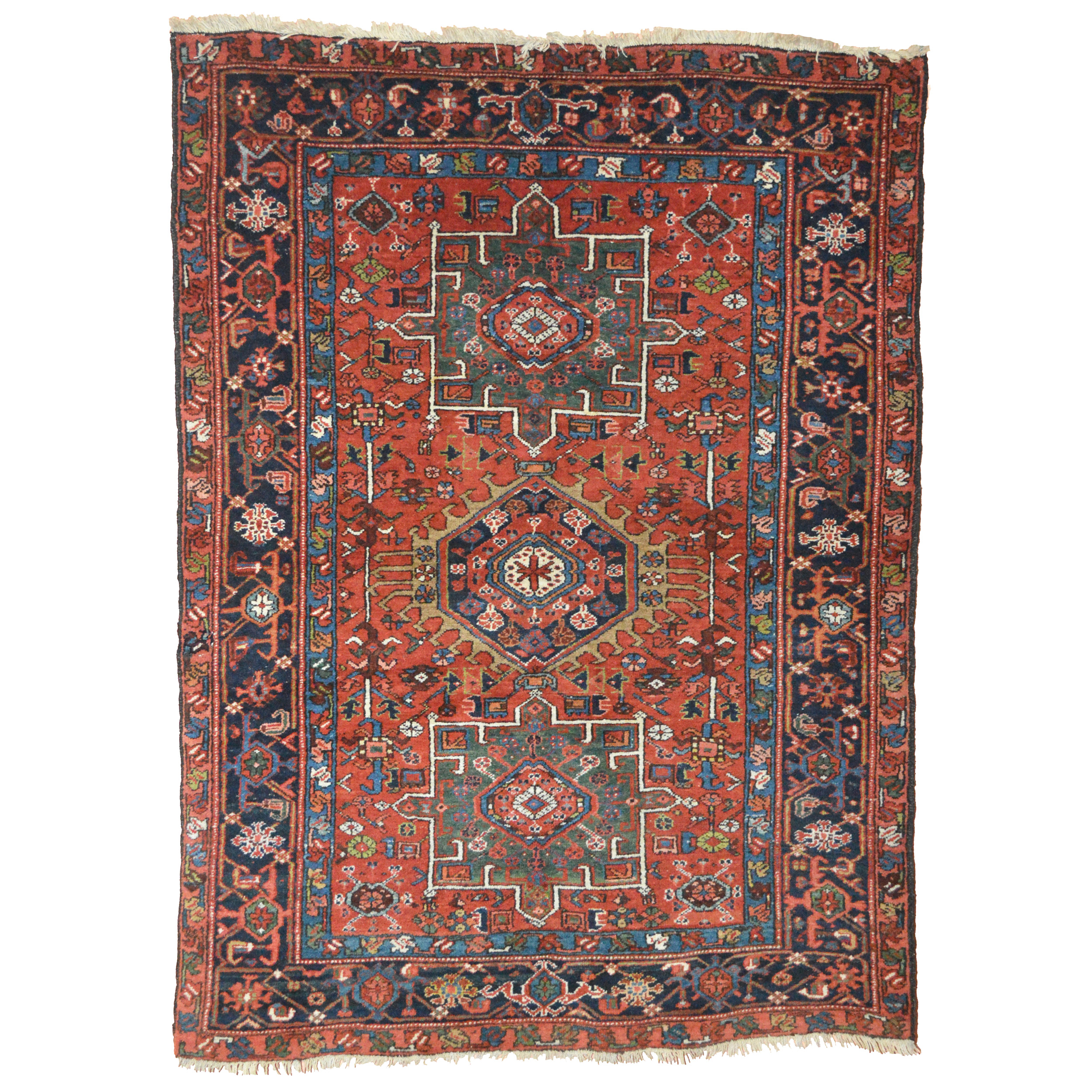 Antique Karaja rug with two green medallions and one navy blue medallion on a salmon color field that is framed by a navy blue border, northwest Persia, circa 1925 - Douglas Stock Gallery