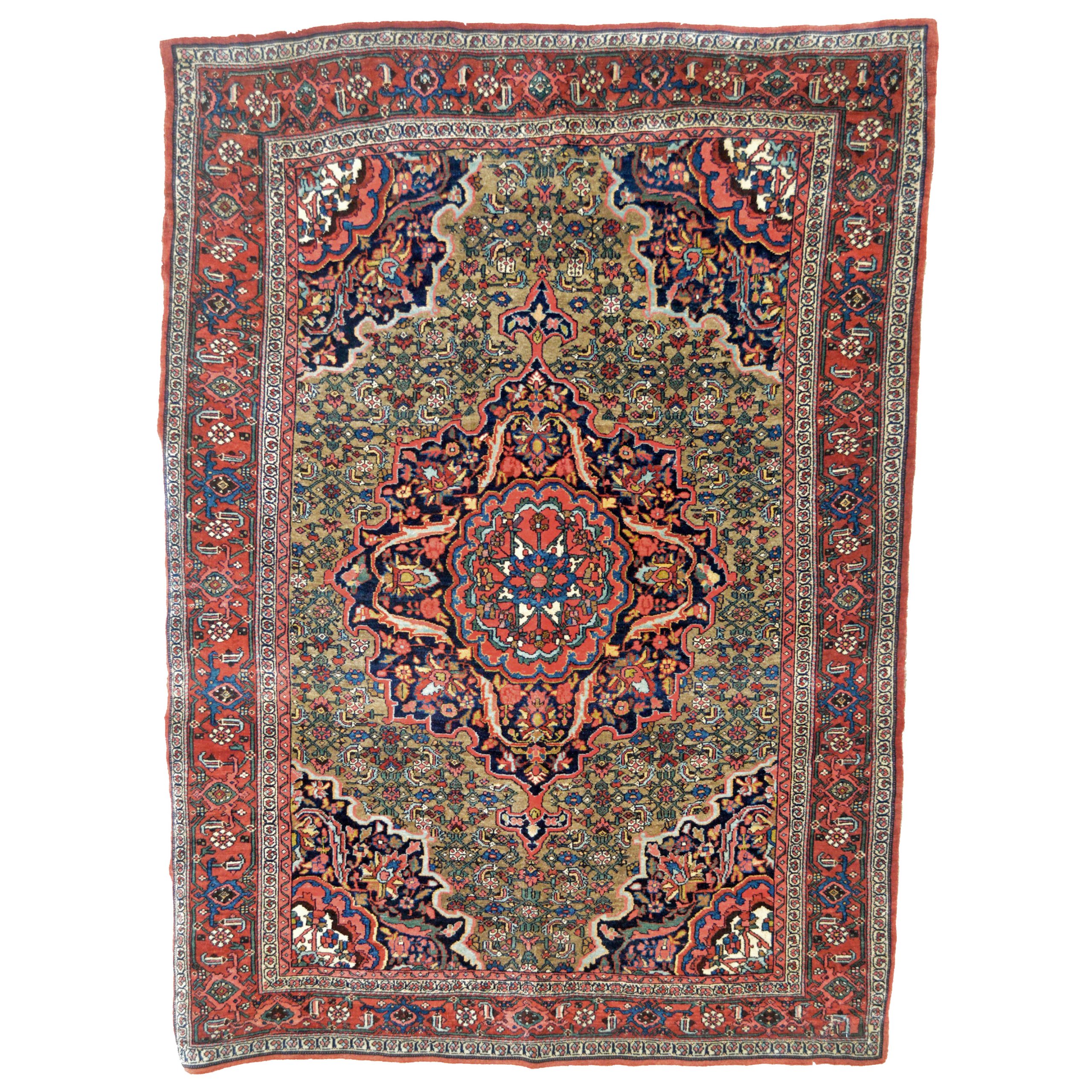 An antique Bidjar rug with an elaborate coral and navy blue medallion on an uncommon camel color field that is decorated with the classical "Herati" design. Coral and navy corner spandrels and a red border decorated with the "Turtle" design frame the field, northwest Persia, Kurdistan province, circa 1920. Douglas Stock Gallery, antique Oriental rugs Boston,MA area, antique Bidjar rugs Boston,MA area, antique Bijar rugs Boston,MA area New England